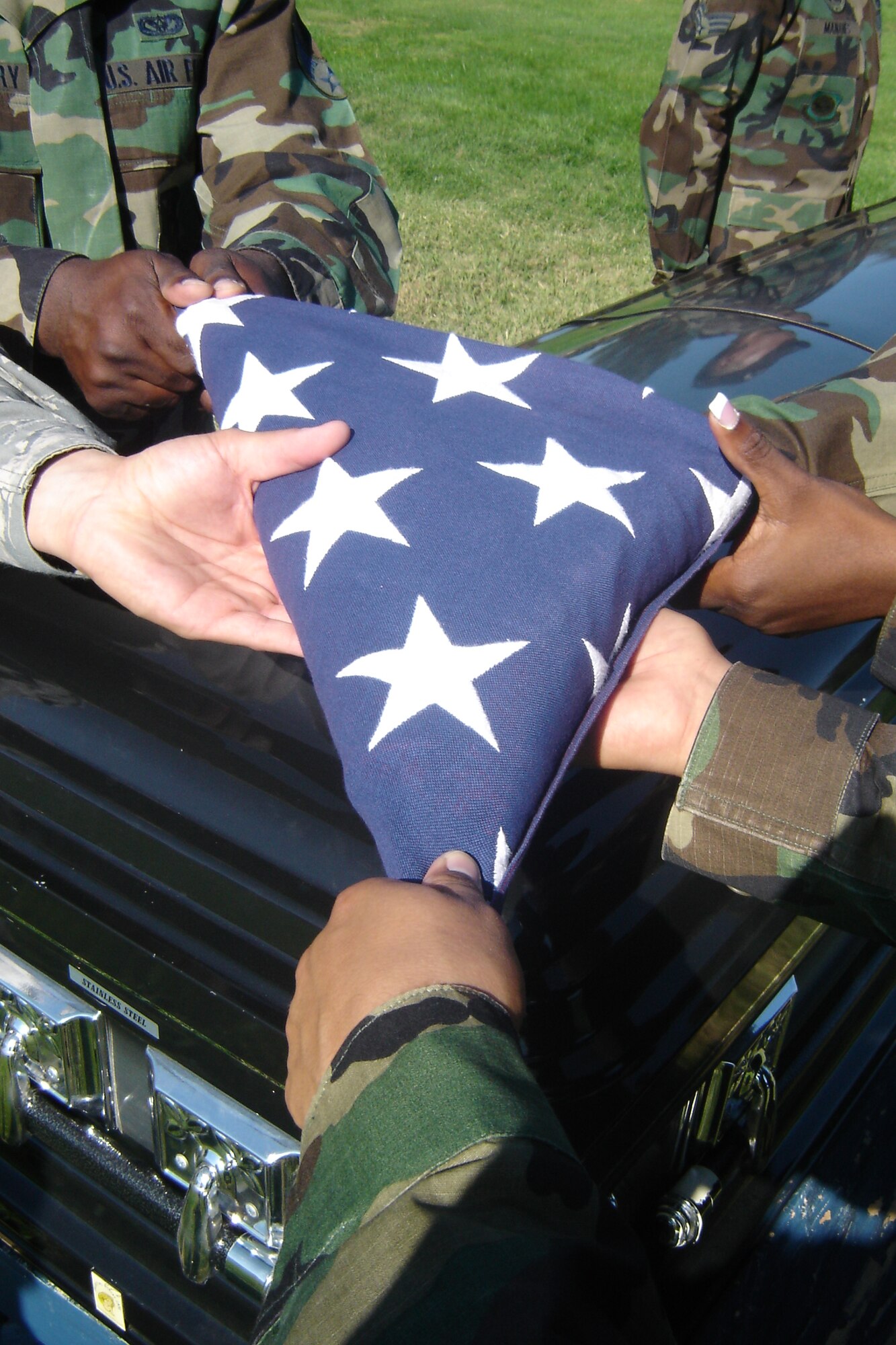 Pallbearers prepare a tri-cornered flag for final inspection. (U.S. Air Force photo by Will Alexander)