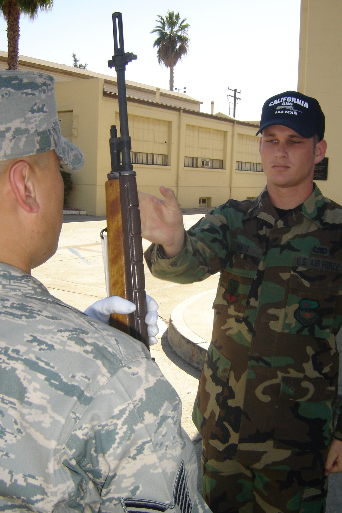 Tech. Sgt. Jason Estrada, left, teaches Senior Airman Ryan Dennis, 163 MXS, how to properly conduct a rifle exchange. (U.S. Air Force photo by Will Alexander)