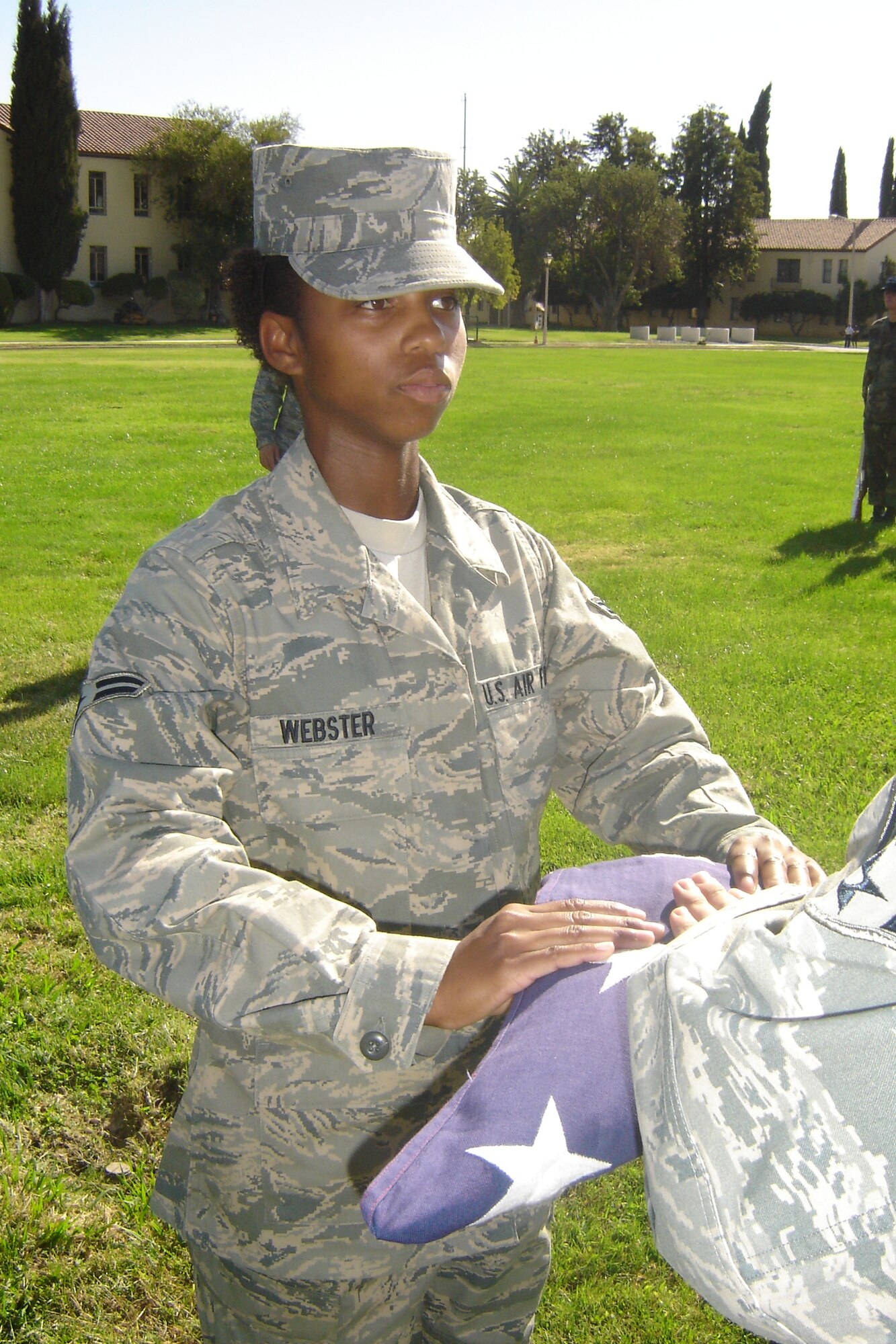 A1C Zakia Webster presents the flag to the next of kin during a mock funeral. (U.S. Air Force photo by Will Alexander)