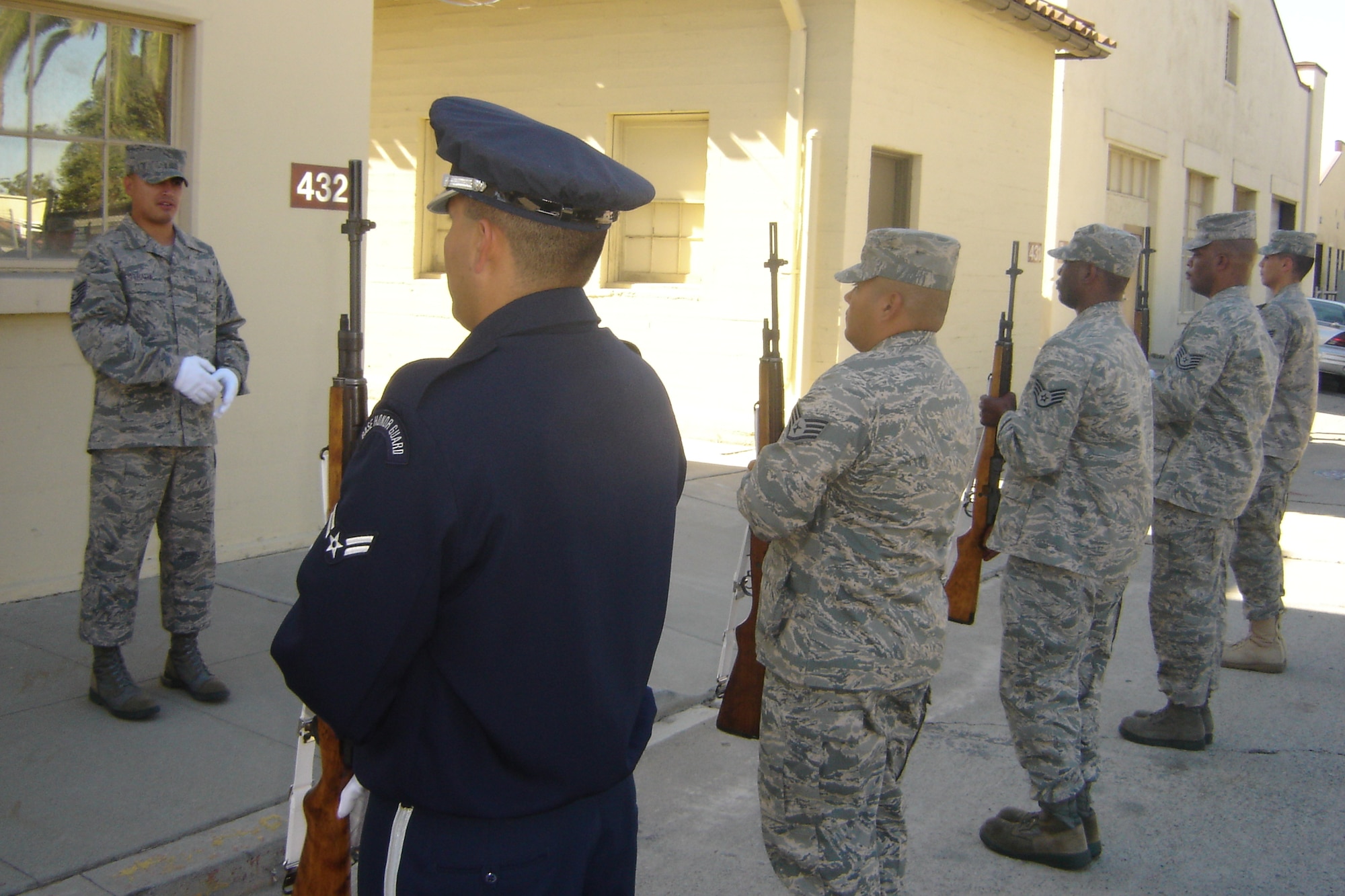 Tech. Sgt. Jason Estrada, USAF Mobile Training Team, teaches “Present Arms” to a student firing party. The movement is usually executed during “Taps.” (U.S. Air Force photo by Will Alexander)