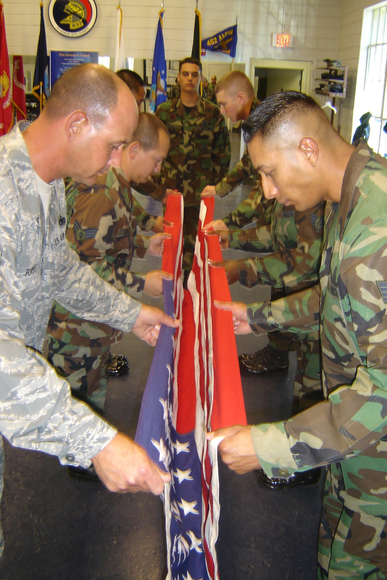 Honor guard students learn how to prepare a flag for a tabletop position for an honors funeral, Oct. 27, inside the March Field Honor Guard building. The training was part of a nine-day course conducted by a three-man Mobile Training Team from the U.S.  Air Force Honor Guard at Bolling AFB, Wash., D.C. (U.S. Air Force photo by Will Alexander)