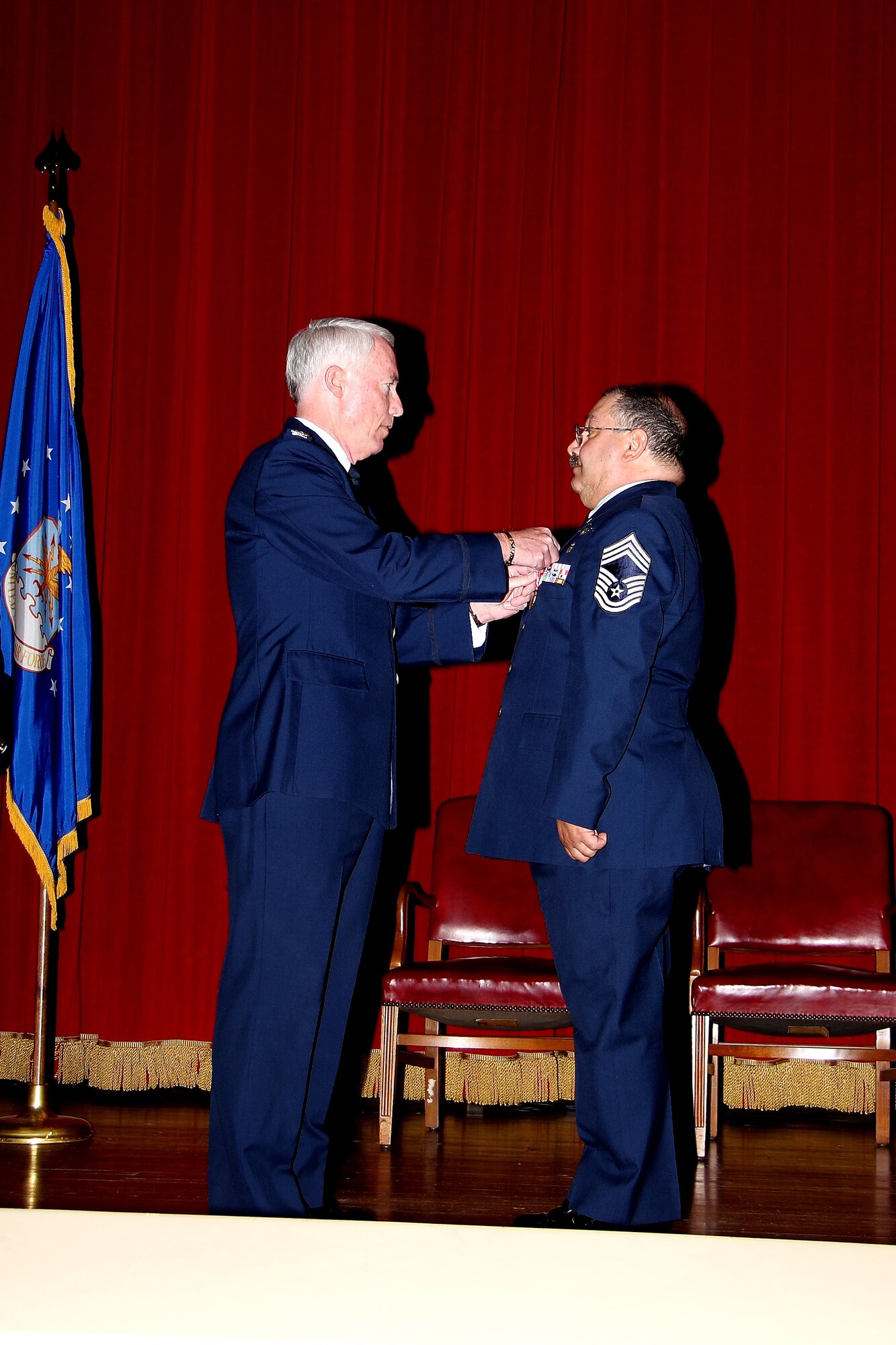 Colonel Ray Butler (left), former commander of the 452 Medical Group, pins the Air Force Meritorious Service Medal on Chief Master Sgt. Louis Ellis during his retirement ceremony, Oct. 19. (U.S. Air Force photo)