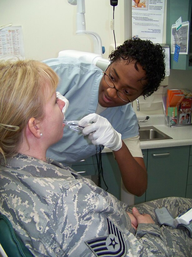ELMENDORF AFB, Alaska -- Senior Airman Opal Smith, 477th Aerospace Medical Flight dental technician, takes a dental x-ray of Tech. Sgt. Michelle Colley during her Physical Health Assessment appointment on November 2.  When fully manned, the 477th AMDF will be responsible for tracking the medical health of a combat-ready force of approximately 425 Air Reserve Technicians and Traditional Reservists to support the active duty and Expeditionary Air Force. (US Air Force Photo by Staff Sgt. Rhiannon Willard)