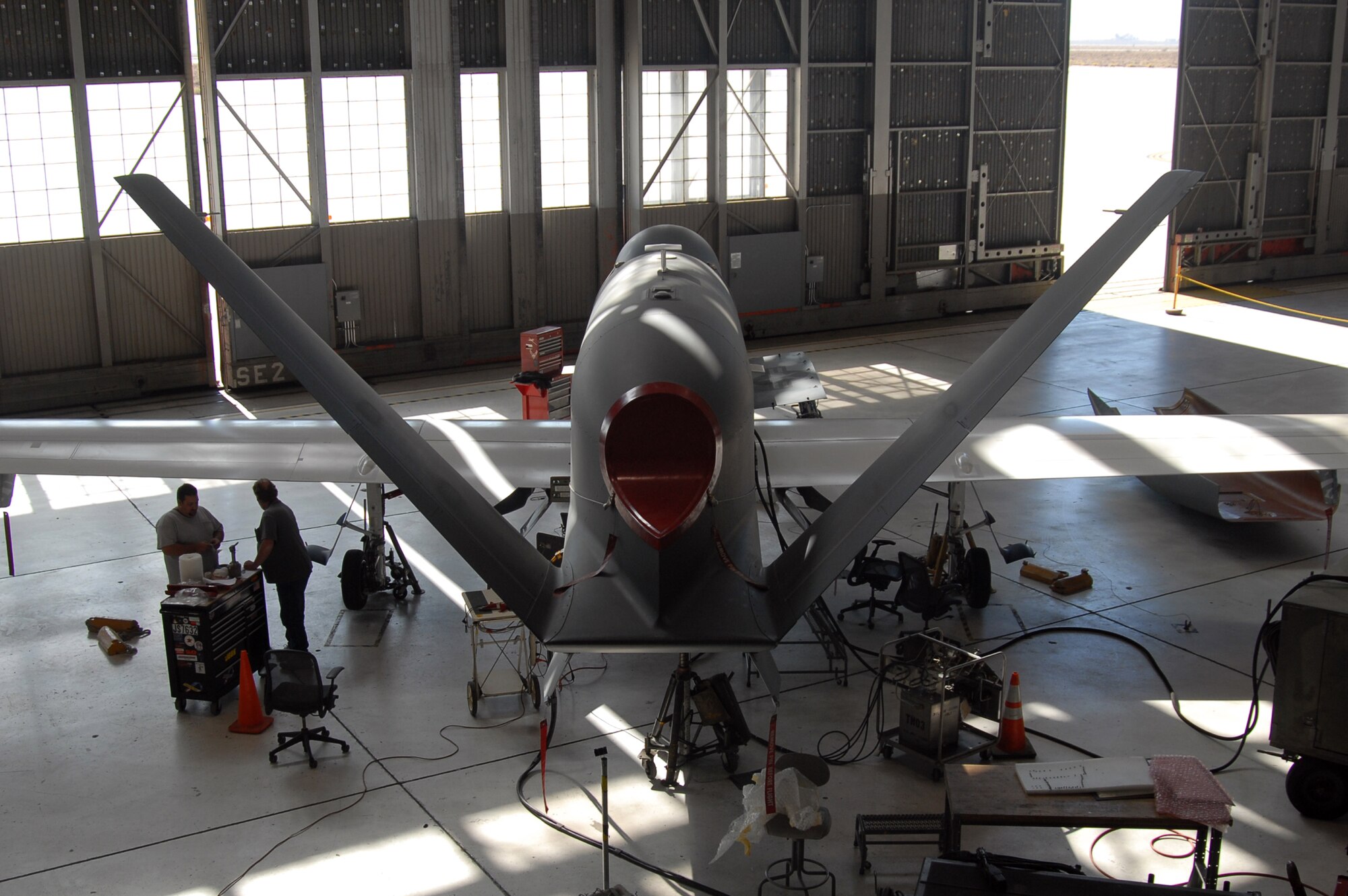 Maintainers with the Global Hawk Combined Test Force perform maintenance on a Global Hawk Oct. 24 at hangar 1414. As part of the Combined Test Force, the 31st Test and Evaluation Squadron test drives the Global Hawk system for the Air Force. (Air Force photo by Senior Airman Julius Delos Reyes)
