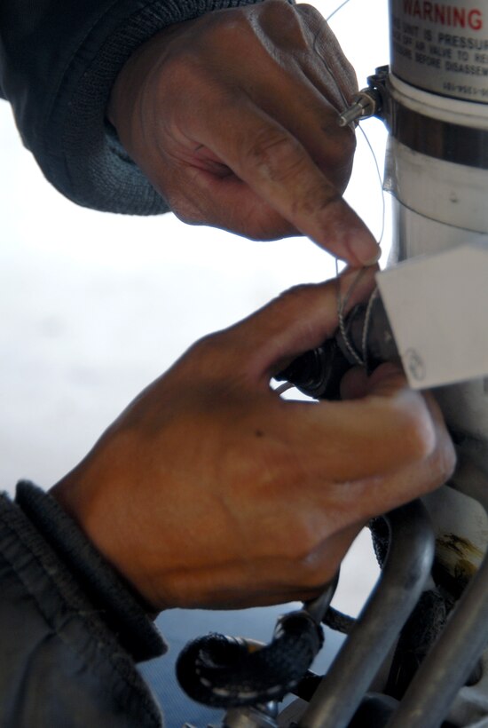 A maintainer with the Global Hawk Combined Test Force performs maintenance on a Global Hawk Oct. 24 at hangar 1414. The Global Hawk Combined Test Force is consist of 31st Test and Evaluation Squadron, 452nd Flight Test Squadron, Air Force Operational Test and Evaluation Center and other test agencies. (Air Force photo by Senior Airman Julius Delos Reyes)