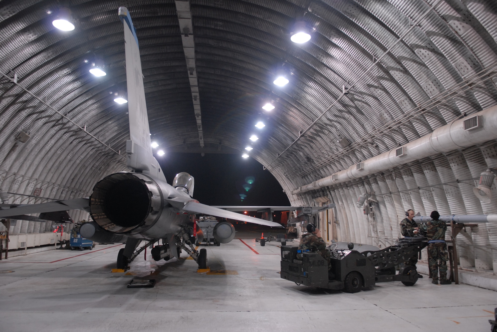 Airman 1st Class Corey Radel, Senior Airman Brianne Brown and Airman 1st Class Joshua Hnatiuk, 8th Aircraft Maintenance Squadron, load a weapon onto the F-16 Fighting Falcon during a peninsula-wide Operational Readiness Exercise Beverly Bulldog 08-04 at Kunsan Air Base, Republic Of Korea, Nov. 4, 2008. Airmen participating in the PENORE will be tested on their wartime capabilities and response actions in order to complete the Wolf Pack mission. (U.S. Air Force photo by: Senior Airman Angela Ruiz/RELEASED by MSgt John Foster)