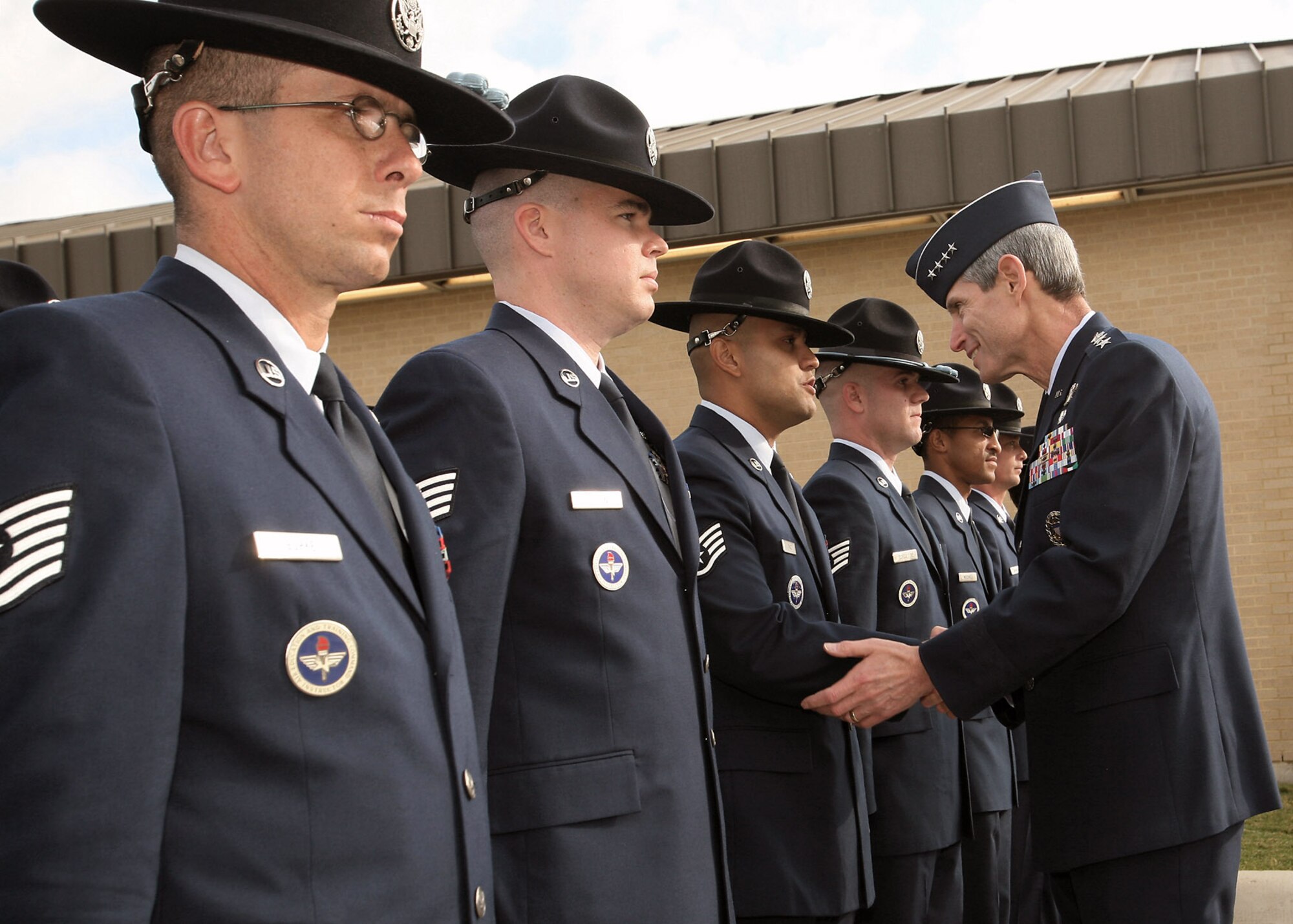 Gen. Norton Schwartz shakes hands with Staff Sgt. Hector Paiz after a Basic Millitary Training graduation Oct. 31 at Lackland Air Force Base, Texas. While on base, General Schwartz administered the oath of enlistment to basic training graduates and served as the reviewing official for the BMT parade. General Schwartz is the Air Force chief of staff. Sergeant Paiz is assigned to the 331st Training Squadron. (U.S. Air Force photo/Robbin Cresswell) 
