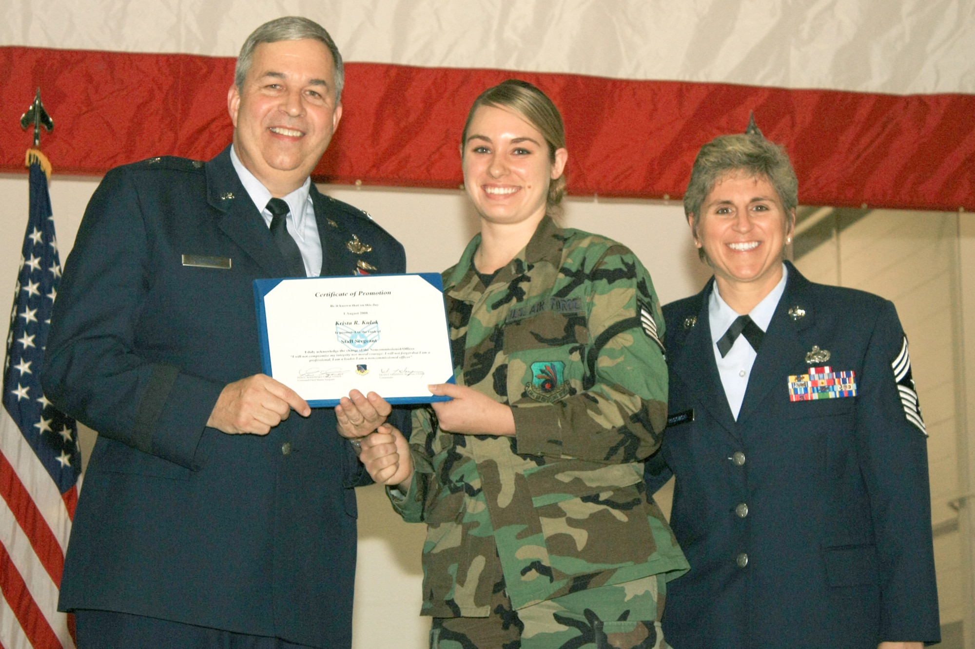 GRISSOM AIR RESERVE BASE, Ind., -- Brig. Gen. Dean Despinoy, 434th Air Refueling Wing commander, left, and Chief Master Sgt. Peri Rogowski, 434th ARW command chief, right, present Staff Sgt. Krista Kulak a certificate to mark her induction into the non-commissioned officer ranks during a promotion ceremony held on the November unit training assembly. (U.S. Air Force photo/Tech. Sgt. Patrick Kuminecz)
