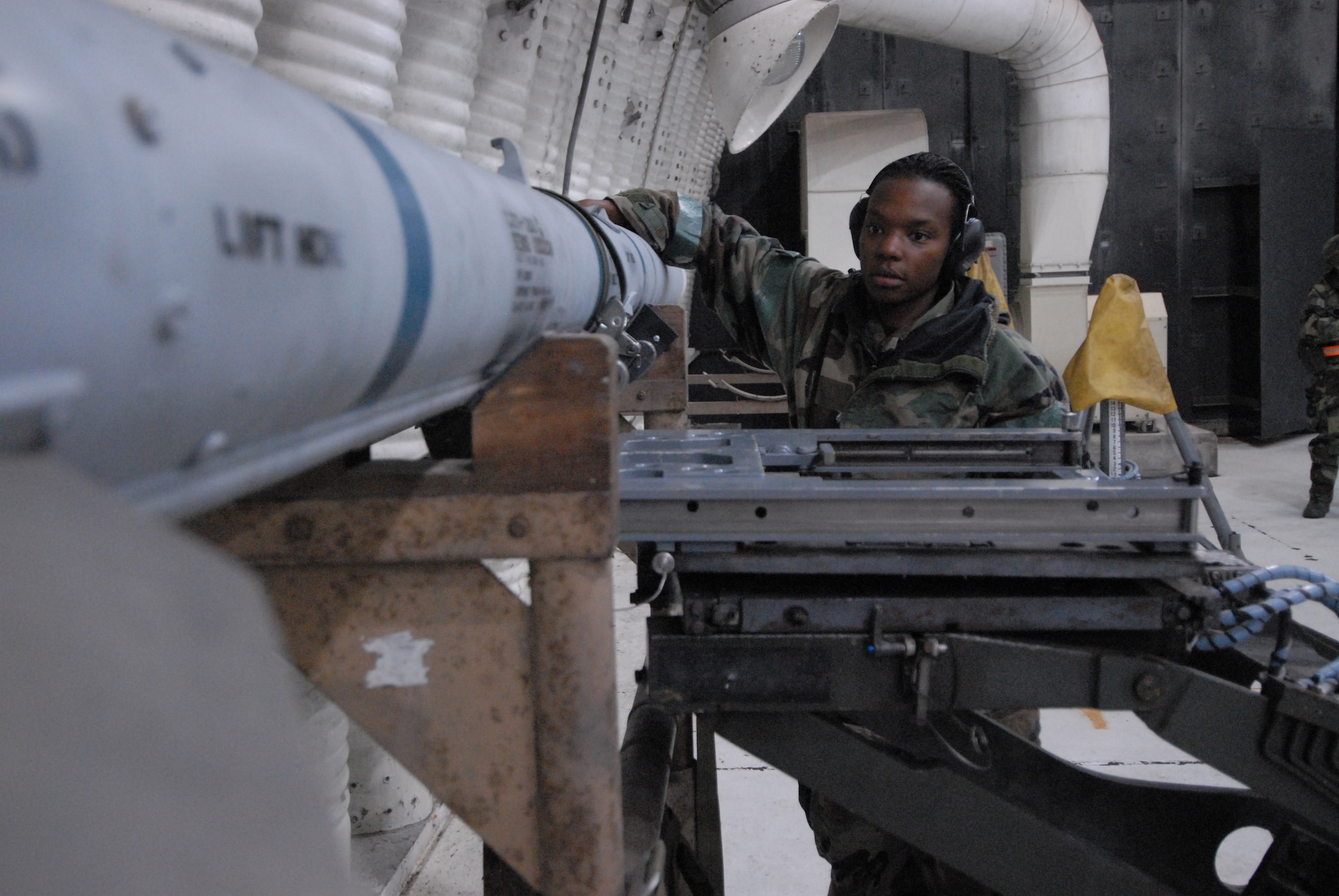 Senior Airman Brianne Brown, 8th Aircraft Maintenance Squadron, prepares to load an Aim 120 missile on an F-16 during exercise Beverly Bulldog 08-04 at Kunsan Air Base, Republic of Korea, November 4, 2008. Kunsan is participating in the Peninsula-Wide Operational Readiness Exercise as a test of its wartime capabilities and response actions. (U.S. Air Force Photo by SrA Gustavo Gonzalez)