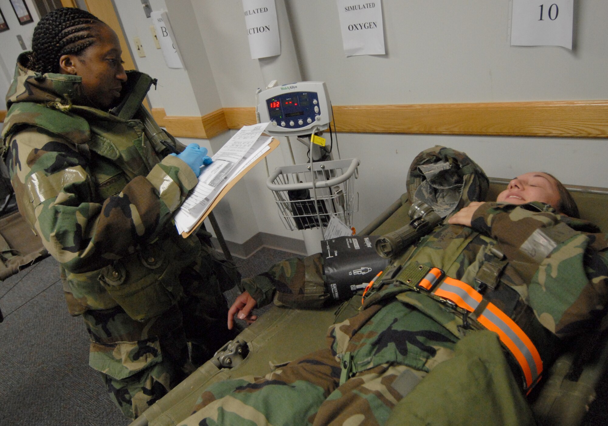 Staff Sgt. Eboni Scott, 8th Medical Group, takes Senior Airman Angela Ruiz's vitals during exercise Beverly Bulldog 08-04 at Kunsan Air Base, Republic of Korea, Nov. 3, 2008. Kunsan is participating in the Peninsula-Wide Operational Readiness Exercise as a test of its wartime capabilities and response actions. (U.S. Air Force Photo by SrA Gustavo Gonzalez)