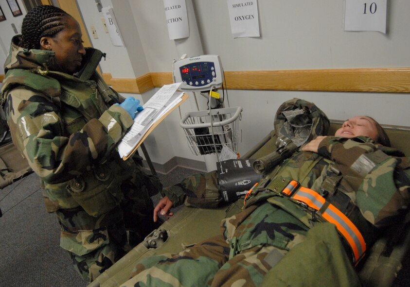 Staff Sgt. Eboni Scott, 8th Medical Group, takes Senior Airman Angela Ruiz's vitals during exercise Beverly Bulldog 08-04 at Kunsan Air Base, Republic of Korea, Nov. 3, 2008. Kunsan is participating in the Peninsula-Wide Operational Readiness Exercise as a test of its wartime capabilities and response actions. (U.S. Air Force Photo by SrA Gustavo Gonzalez)
