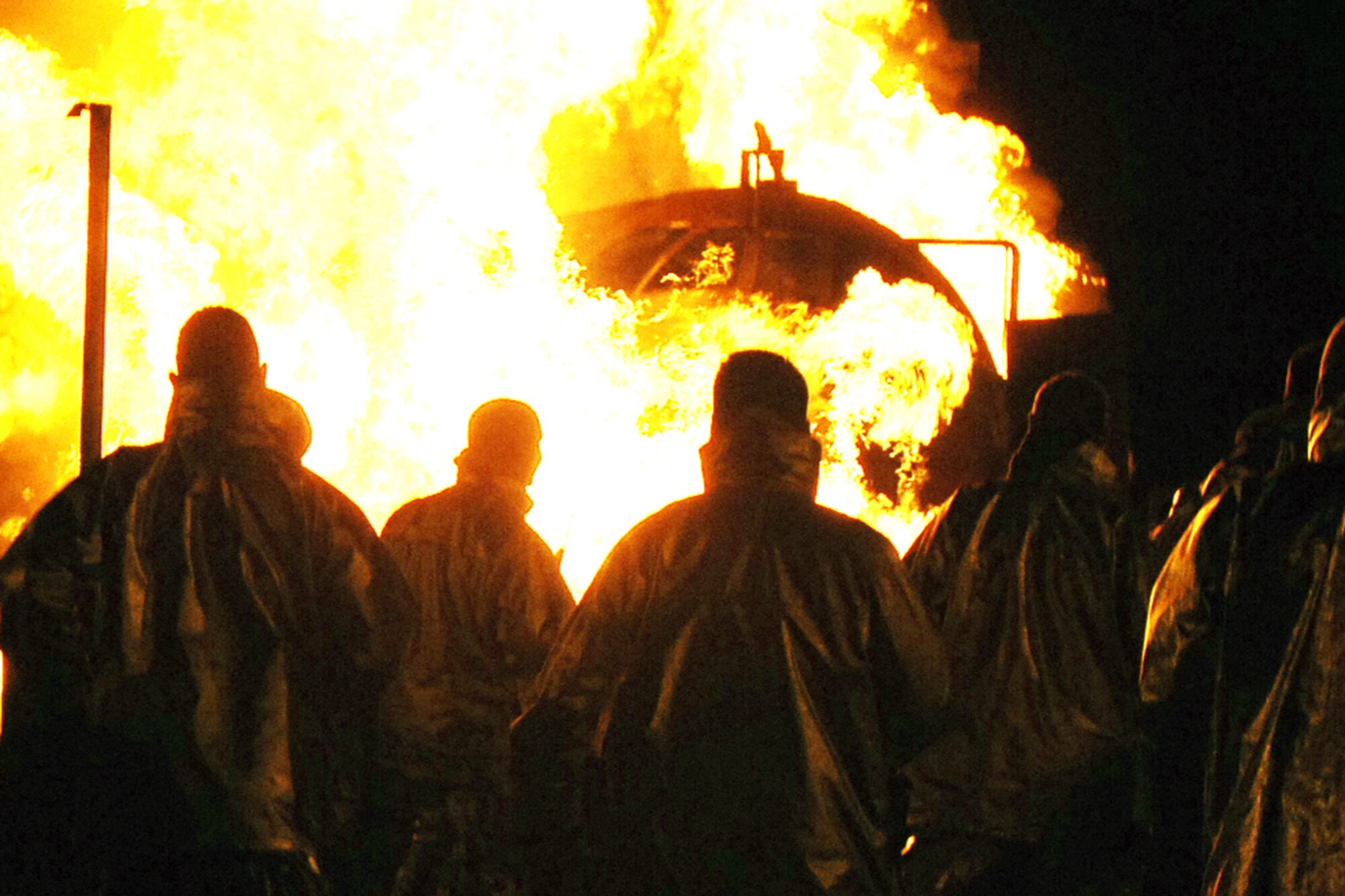 GRISSOM AIR RESERVE BASE, Ind., -- Reserve firefighters of the 434th Civil Engineer Squadron watch as the fire training simulator is ignited. The reservists trained on fighting aircraft fires during a recent nighttime training exercise.  (U.S. Air Force photo/Senior Airman Carl Berry)