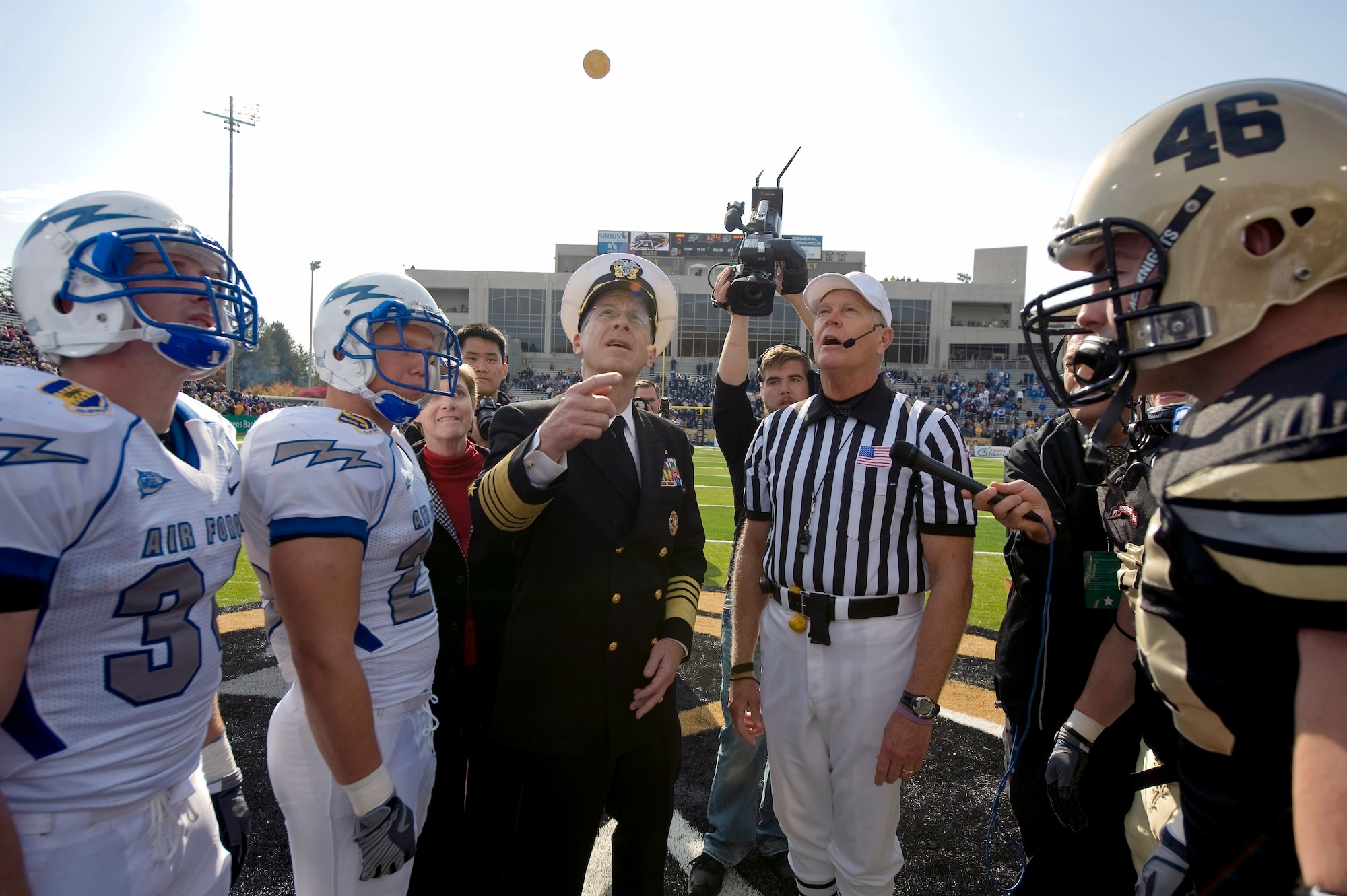 Navy Adm. Michael G. Mullen flips a coin at the beginning of the U.S. Military Academy and U.S. Air Force Academy football game Nov. 1 at West Point, N.Y. The Falcons defeated the Black Knights 16-7 in the annual battle. Admiral Mullen is the chairman of the Joint Chiefs of Staff. (Defense Department photo/Navy Petty Officer 1st Class Chad J. McNeeley) 