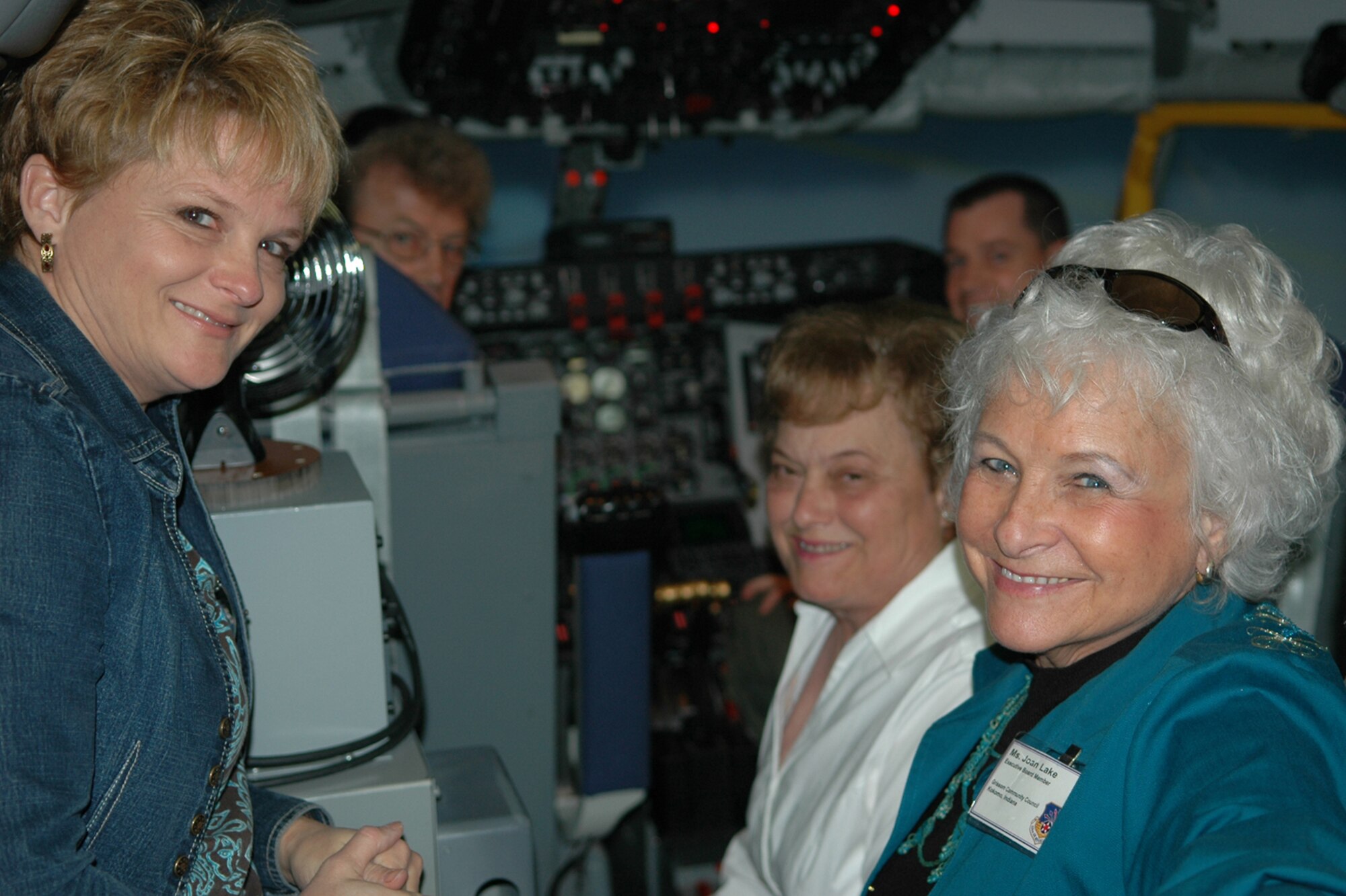 GRISSOM AIR RESERVE BASE, Ind., -- Tanya Cox (left) and Joan Lake wait to test their skills in the KC-135R flight simulator. The two were part of a group of Grissom Community Council members who visited the base Nov. 1. The interactive base tour also included visits to aircrew life support and the radar approach control center.  (Air Force Photo/Master Sgt. Rob Hoffman)