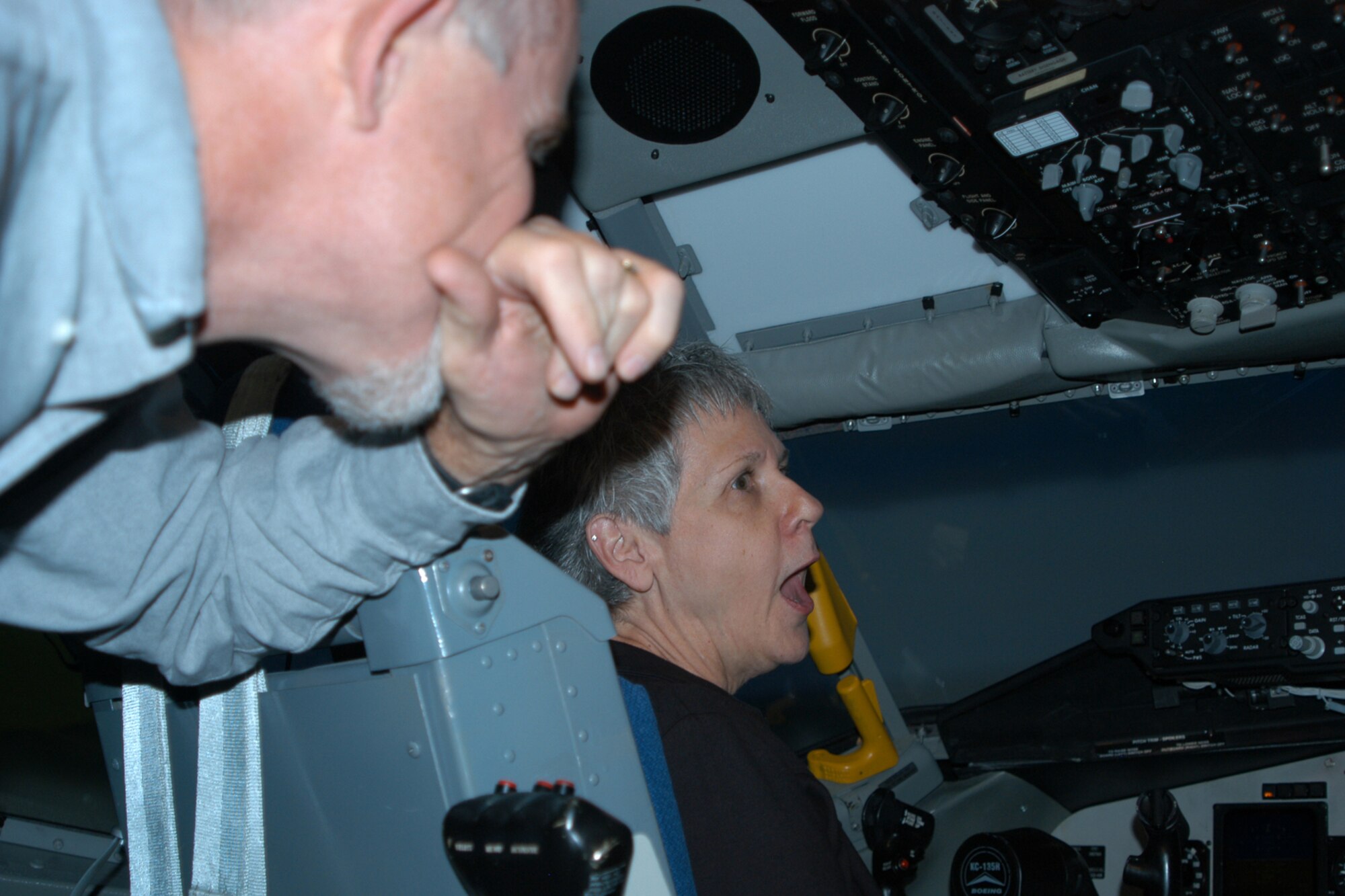GRISSOM AIR RESERVE BASE, Ind. -- Col. (ret) John Salmon watches as his wife Nancy attempts a "landing" in the KC-135R flight simulator. The Salmon's, members of the Grissom Community Council, participated in an interactive tour of the base Nov. 1 that included stops at the KC-135 simulator, the new radar approach control facility and aircrew life support. (U.S. Air Force photo/Capt. Kelly Howard)