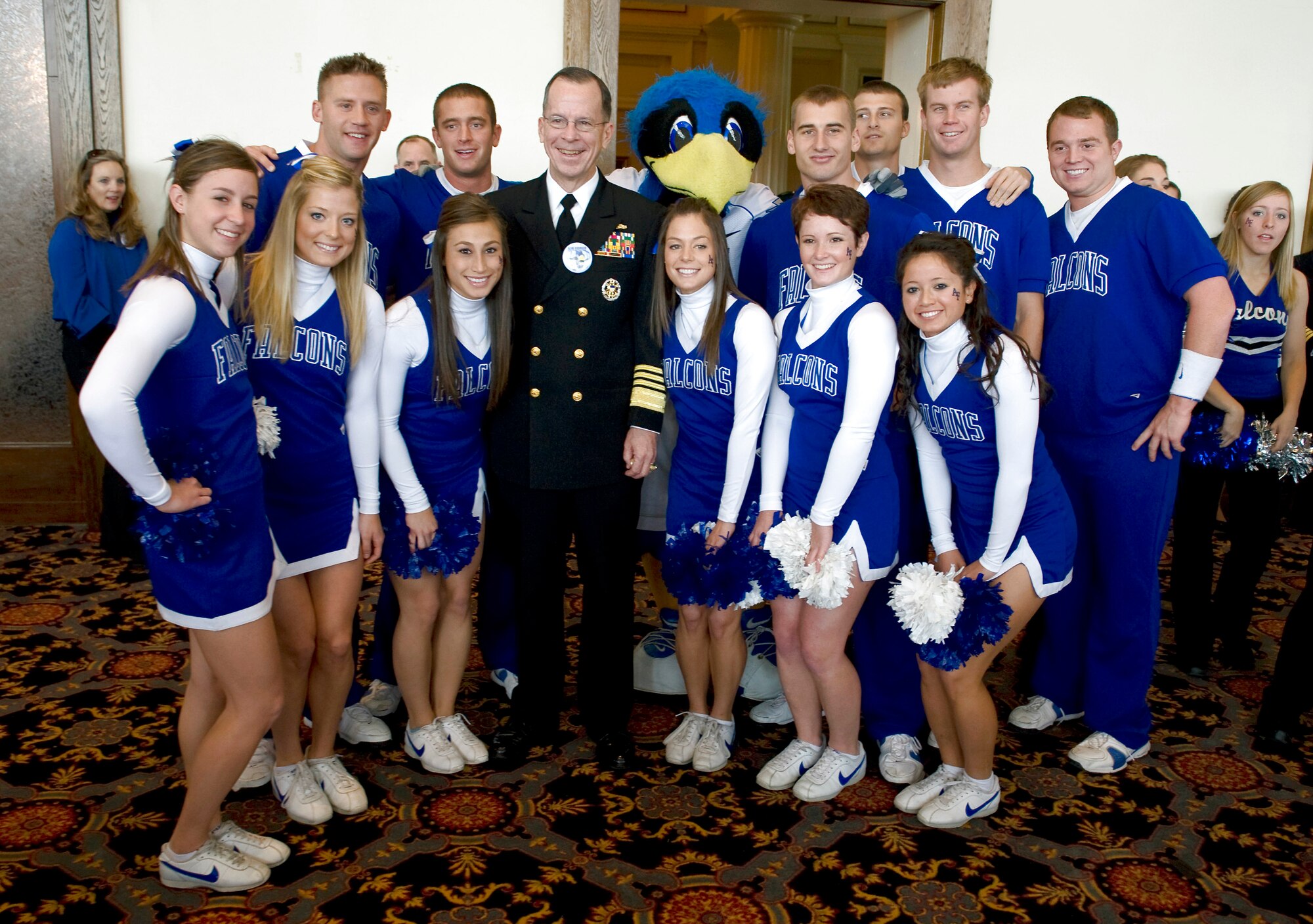 Navy Adm. Michael G. Mullen poses with the U.S. Air Force Academy cheerleaders at a tailgating party before the football game versus the U.S. Military Academy Black Knights Nov. 1 at West Point, N.Y. Admiral Mullen is the chairman of the Joint Chiefs of Staff. (Defense Department photo/Navy Petty Officer 1st Class Chad J. McNeeley)
