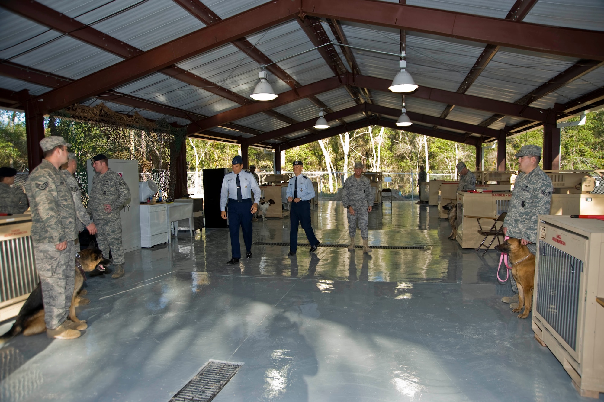 Col. Rick LoCastro, 96th Air Base Wing vice commander and Capt. Ben Jacobson, Ground Combat Training Squadron commander, tour the military working dog kennel that is now part of GCTS. The squadron is a pre-deployment training course that opened here in 2002. The course, known as Brave Defender, was originally established by Air Force Materiel Command to satisfy security forces training requirements in an expeditionary environment. (USAF photo/Greg Murry)