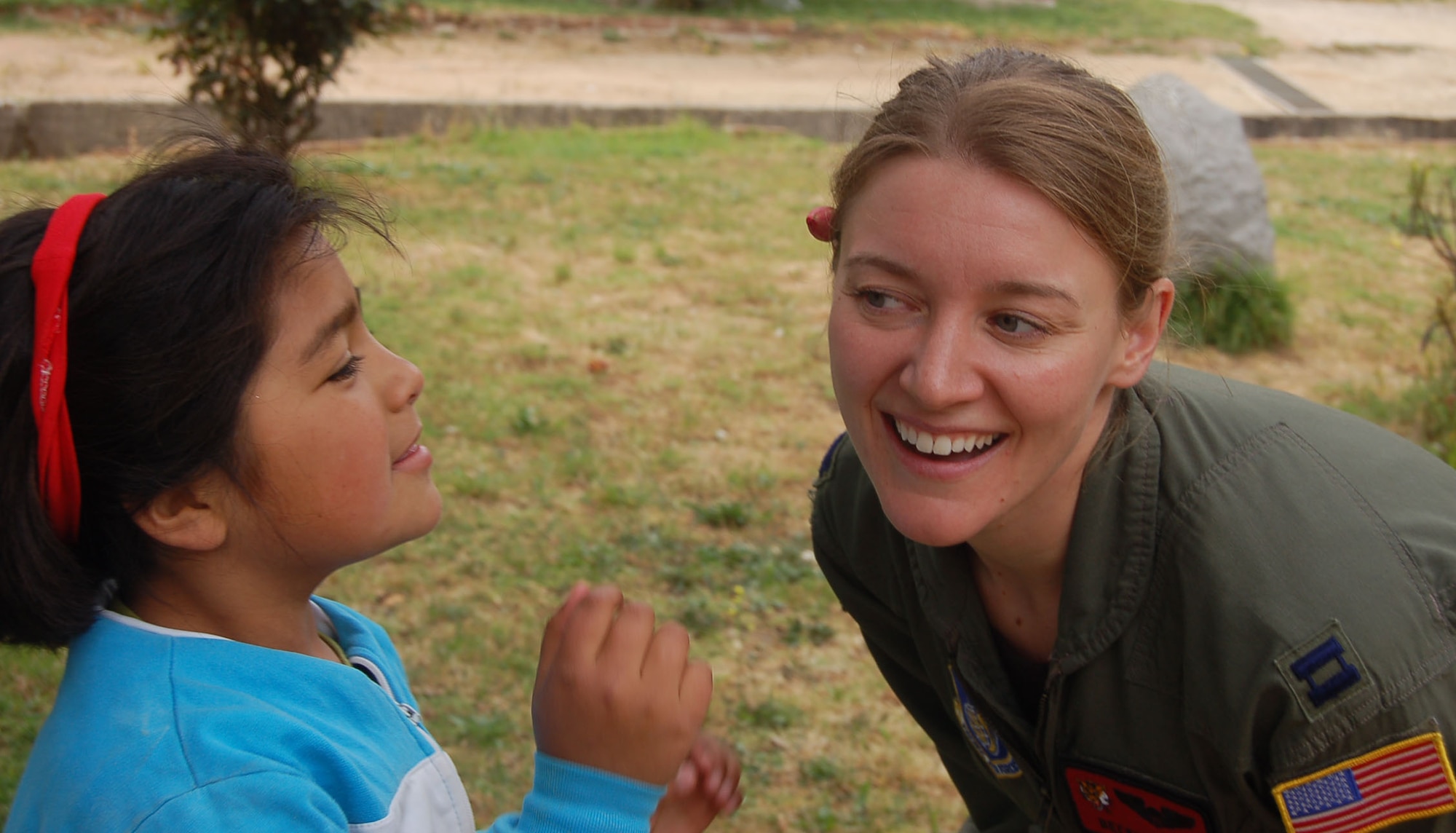 Capt. Becky Russo is all smiles after recieving a flower Oct. 31 from a Chilean girl during a visit to ALDEAS SOS orphanage in Quilpué, Chile. Captain Russo, a C-17 Globemaster III aircraft commander from the 535th Airlift Airlift Squadron at Hickam Air Base, Hawaii, visited the orphanage while on a community outreach program during Operation Southern Partner, a Twelfth Air Force (Air Forces Southern) led event aimed at providing intensive, periodic subject-matter exchanges in the U.S. Southern Command area of focus. (Air Force photo/Master Sgt. Eric M. Grill)