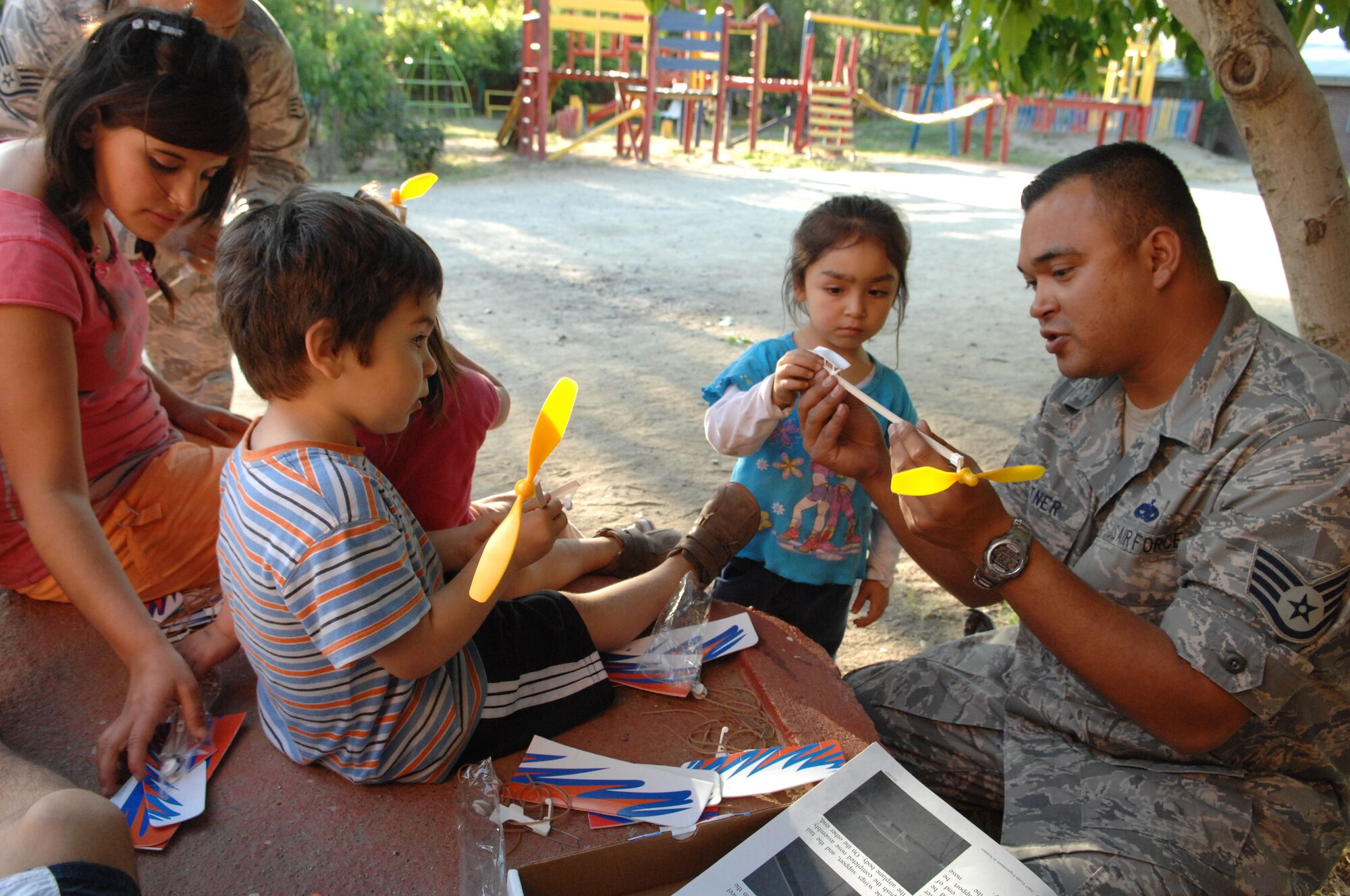 Staff Sgt. Lee Fortner, an aircraft maintainer from the 355th Maintenance Group at Davis Monthan Air Force Base, Ariz., demonstrates how to build a model airplane to orphans at a Santiago, Chile orphanage on Oct. 30. Sergeant Fortner is one of about 70 Airmen spread across four South American countries learning and sharing with their partner nations' military members and performing community outreach events as part of Operation Southern Partner -- a Twelfth Air Force (Air Forces Southern) led event aimed at providing intensive, periodic subject-matter exchanges in the U.S. Southern Command area of focus. (Air Force photo/Tech. Sgt. Roy Santana)