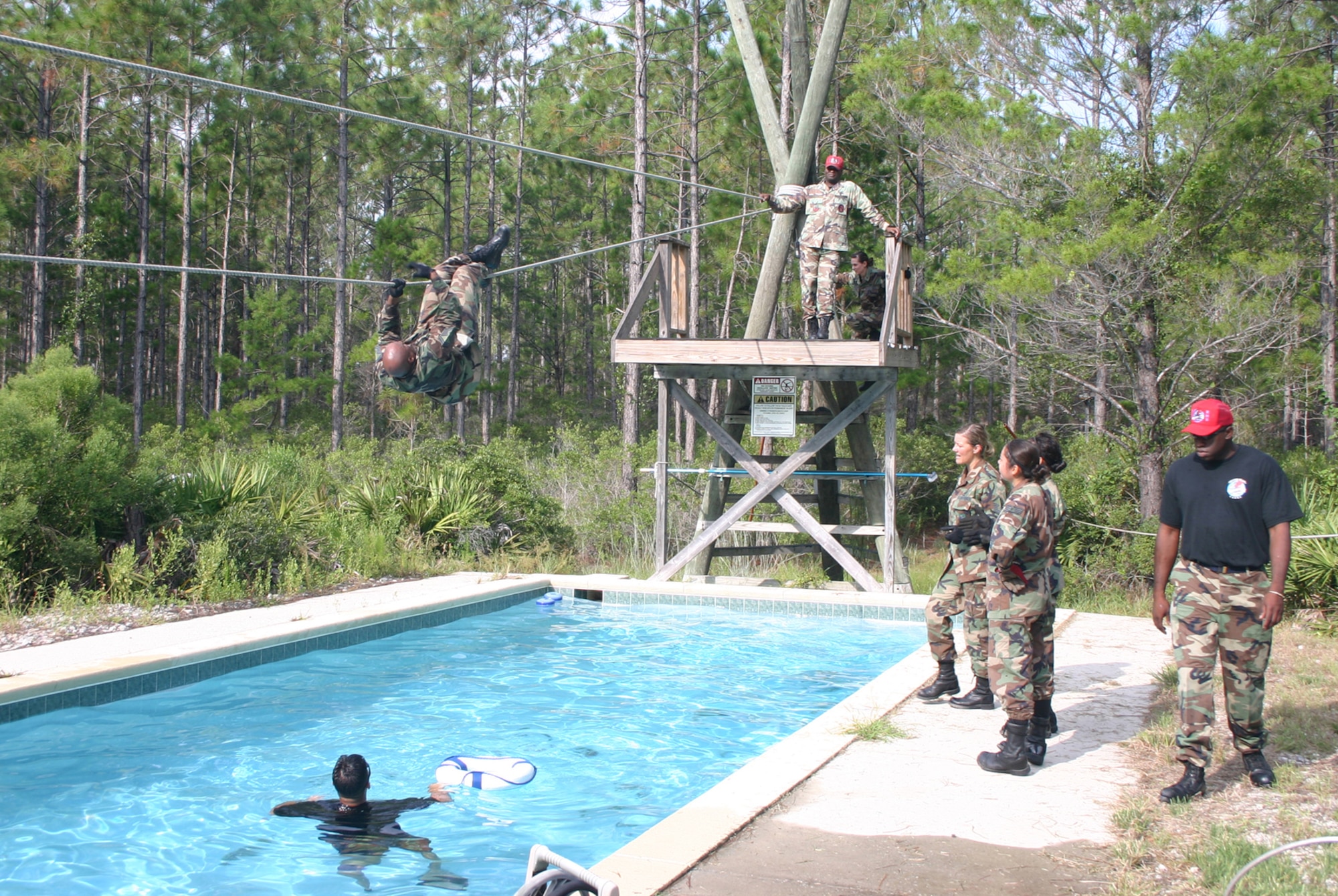 PERSCO team member Tech. Sgt. Don White attempts the last of the 13 stations on the 823rd Red Horse Squadron's obstacle course Sept. 17 during a week-long Silver Flag exercise at Tyndall Air Force Base, Fla.  In the area of responsibility, PERSCO teams maintain accountability for all deployed Airmen and provide accurate tracking of personnel by name, Air Force specialty code, grade, gender and other factors. (U.S. Air Force photo/Richard Salomon) 