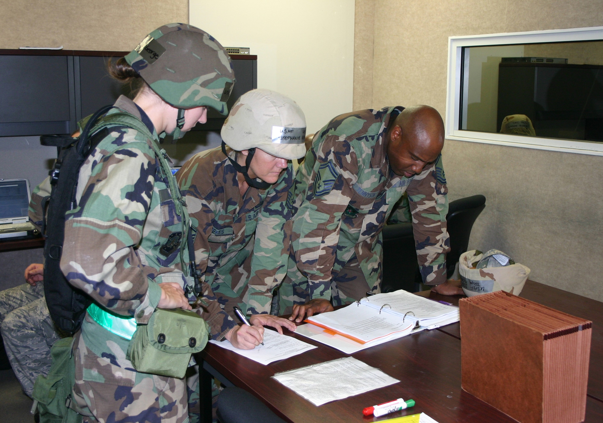 PERSCO team members (from left) 2nd Lt. Melissa George, Master Sgt. Stephanie Kerekes and Senior Master Sgt. Nate Tennyson, review casualty procedures during a recent Silver Flag exercise at Tyndall Air Force Base, Fla.  Deployed PERSCO teams are responsible for casualty reports that provide vital information to the Air Force Casualty Office and Red Cross, so family members are immediately notified if a tragedy occurs. (U.S. Air Force photo/Richard Salomon)