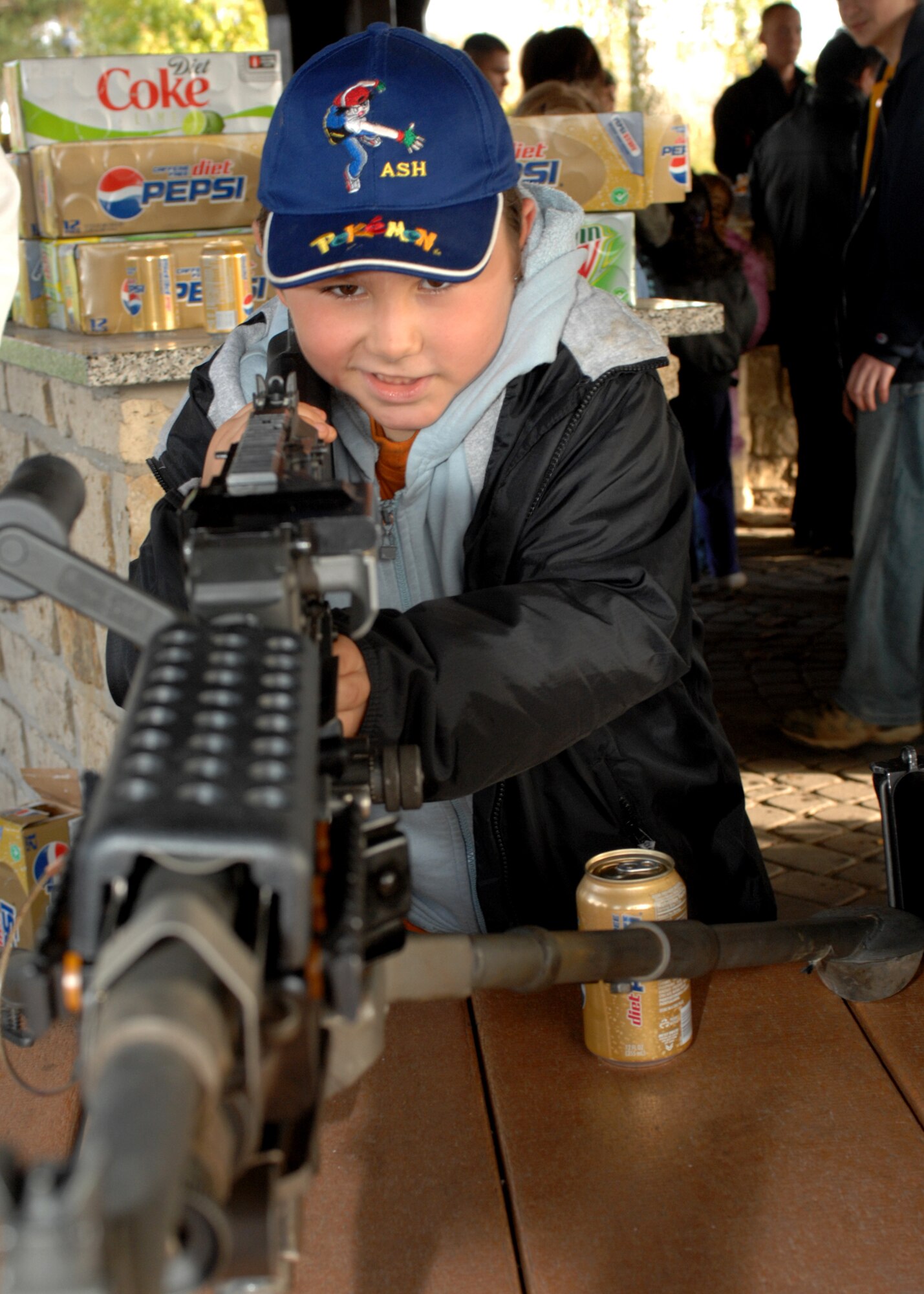 SPANGDAHLEM AIR BASE, Germany -- Children from the Speicher Orphanage look at the different weapons that are used by the 52nd Security Forces Squadron Oct. 25, 2008.  The children got a chance to view the weapons during the barbecue.  Hamburgers and hotdogs were donated by the Defense Commissary Agency, the Defenders Association and various security forces members. (U.S. Air Force photo by Airman 1st Class Jenifer H. Calhoun)