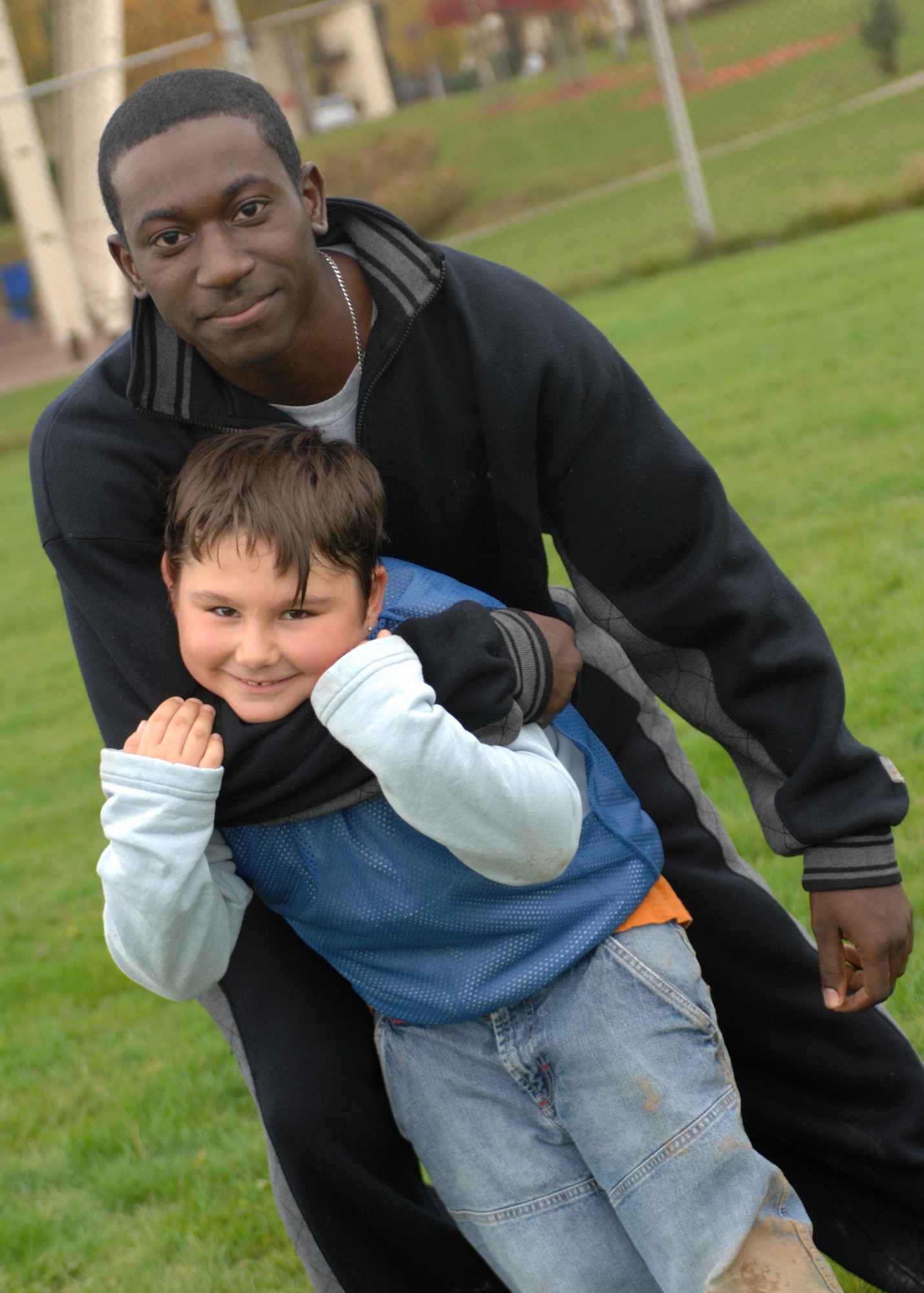 SPANGDAHLEM AIR BASE, Germany – Airman 1st Class Markcellous Wright, 52nd Security Forces Squadron, plays with children from the Speicher Orphanage at the Spangdahlem Air Base Softball Field Oct. 25, 2008.  Children got a chance to play against the security forces Airmen and won. (U.S. Air Force photo by Airman 1st Class Jenifer H. Calhoun)