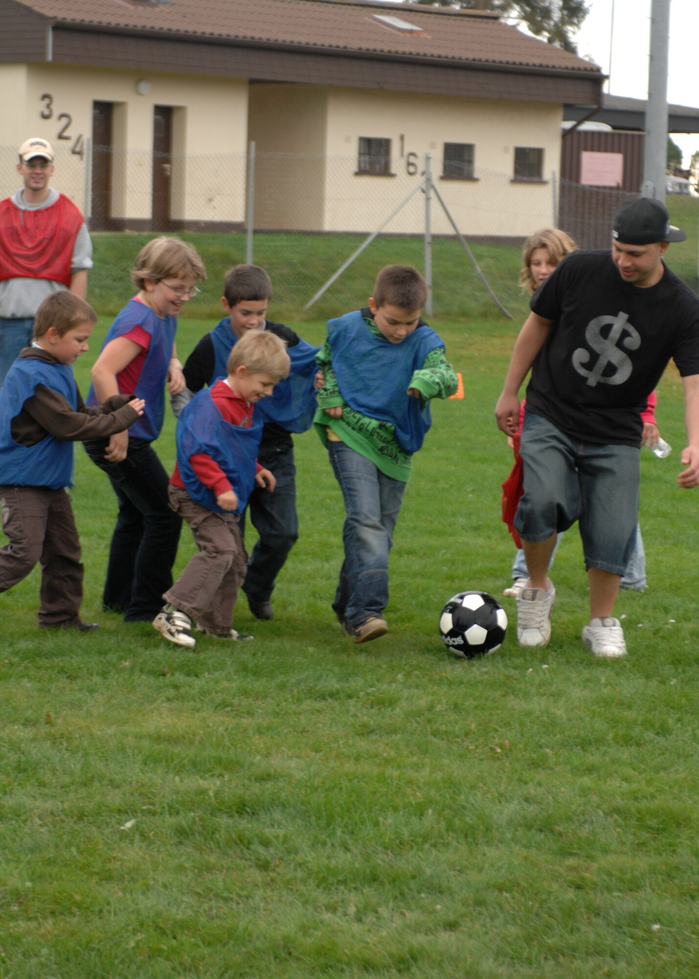 SPANGDAHLEM AIR BASE, Germany -- 52nd Security Forces Squadron  Airmen play soccer with children from the Speicher Orphanage at the Spangdahlem Air Base Softball Field Oct. 25, 2008.  (U.S. Air Force photo by Airman 1st Class Jenifer H. Calhoun)

