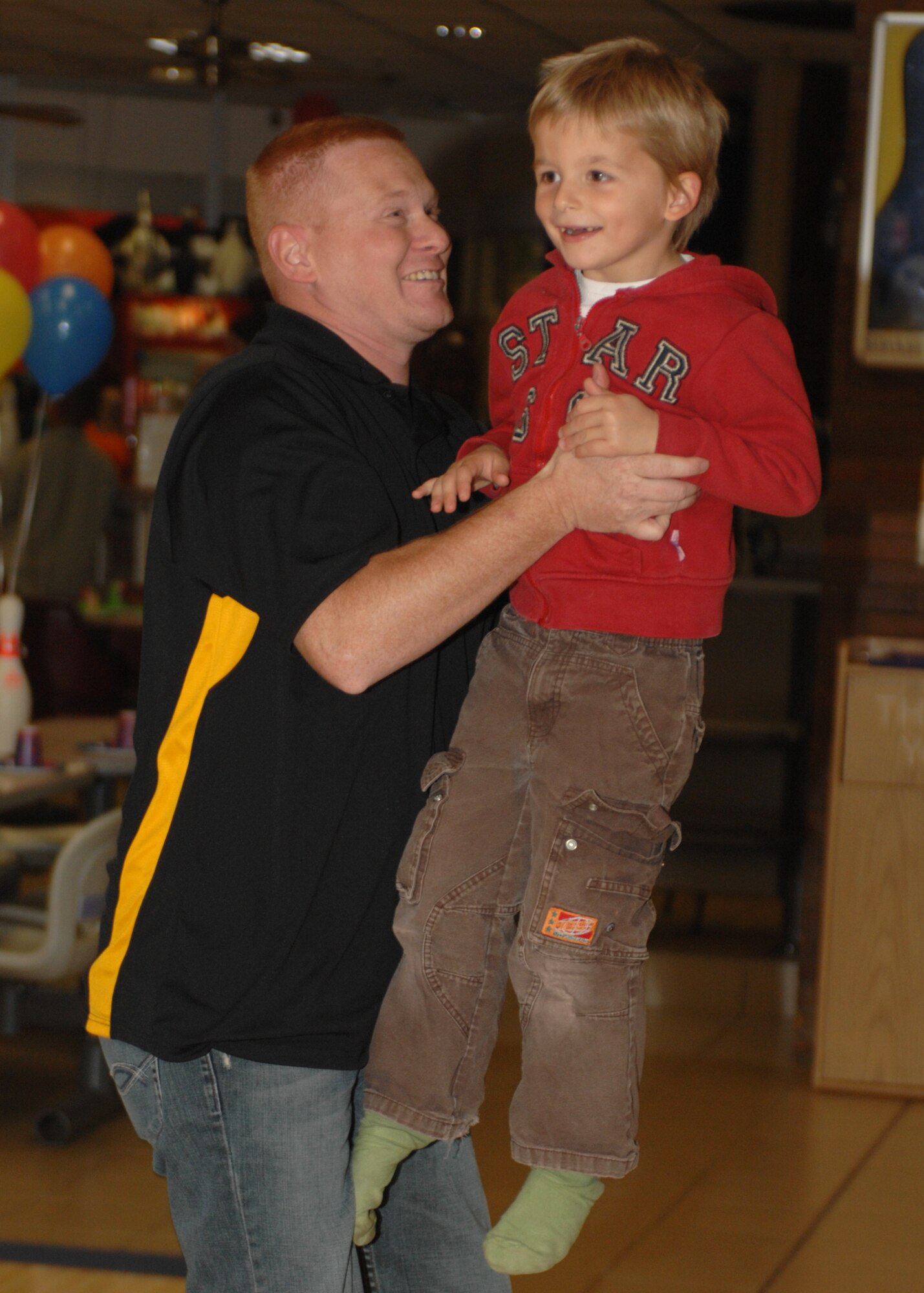 SPANGDAHLEM AIR BASE, Germany – Tech. Sgt. Paul Niswonger congratulates a child as he bowls at the Eifel Lanes Bowling Center Oct. 25, 2008.  The children participated in bowling and soccer with members of the 52nd Security Forces Squadron. Master Sgt. Steven Koehler said that they “just want to make an impact and give back to a community that has given them so much.” (U.S. Air Force photo by Airman 1st Class Jenifer H. Calhoun)