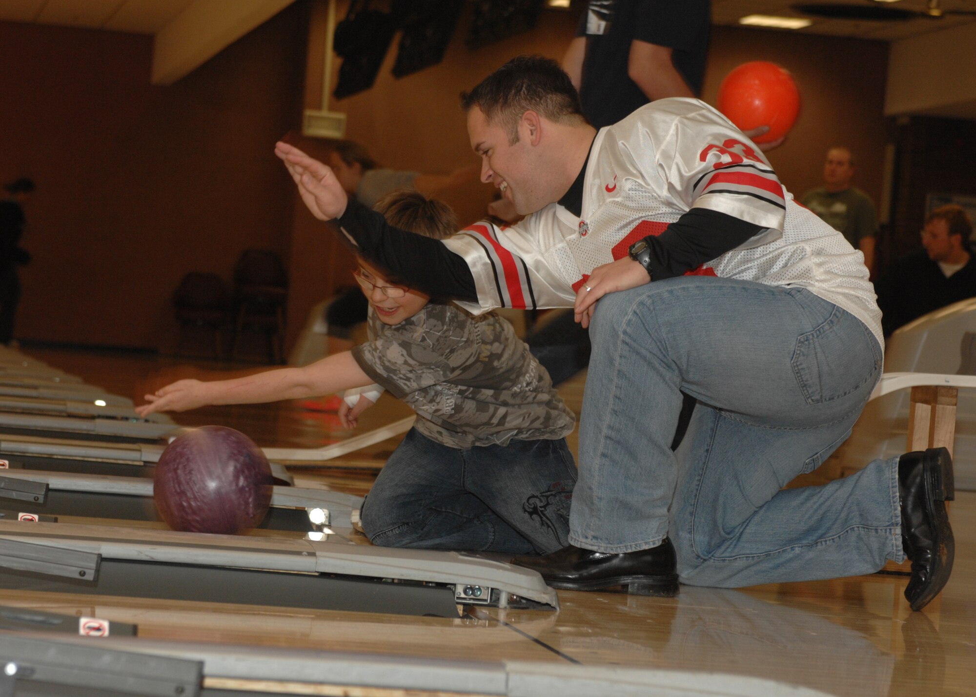 SPANGDAHLEM AIR BASE, Germany – Staff Sgt. Brian Cikity, 52nd Security Forces Squadron, shows children from the Speicher Orphanage just one of the fun techniques to use when bowling at the Eifel Lanes Bowling Center Oct. 25, 2008.  This is the second time within the year that security forces has planned a day out with the children and took request on what they wanted to do the next time they came to the base.  The children’s response was “to go bowling and see planes.” (U.S. Air Force photo by Airman 1st Class Jenifer H. Calhoun)