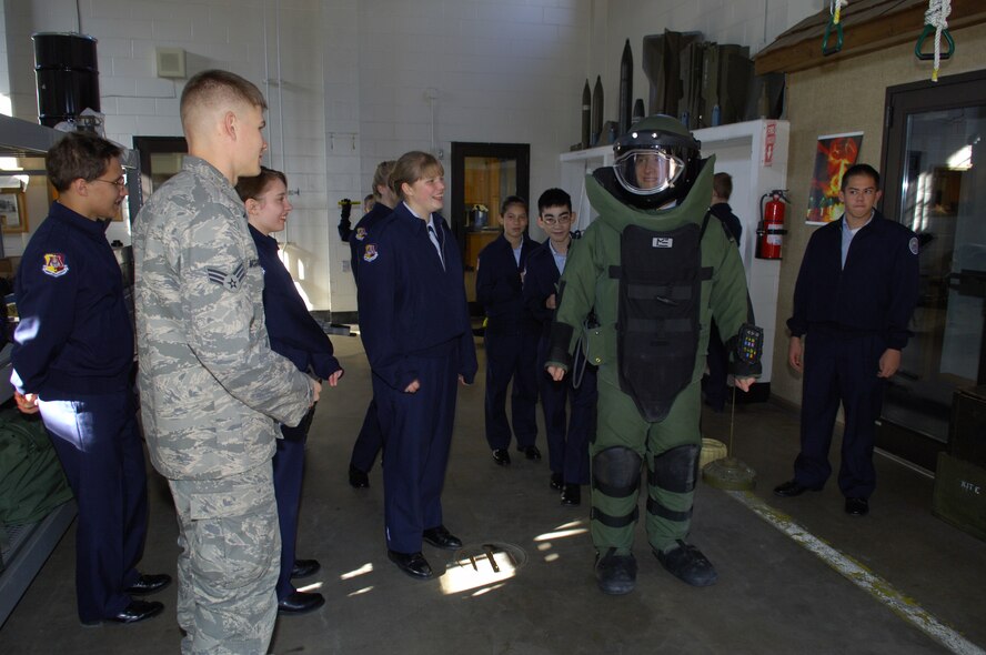 MINOT AIR FORCE BASE, N.D. -- A member of the Air Force Junior ROTC detachment from Minot High School (Magic City campus), tries on a 9 bomb suit at 5th Civil Engineer Squadron’s explosive ordnance disposal section here Oct. 23. Members of the detachment spent the day with the 5th Bomb Wing in order to familiarize themselves with technical specialties like aircraft maintenance, EOD and vehicle operations.