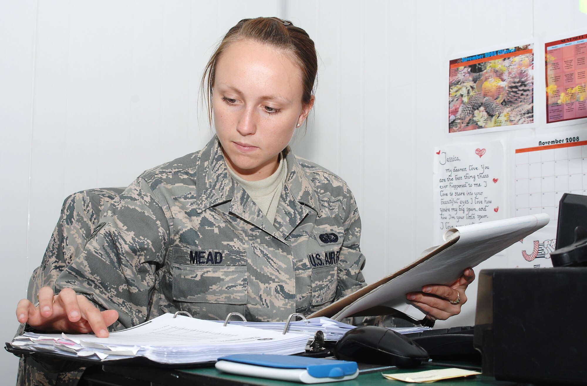 ALI BASE, Iraq -- Senior Airman Jessica Mead, 407th Expeditionary Force Support Squadron personal trainer, creates a exercise program from a new client. Mead factors in a client's body fat measurement, weight and current fitness level into the programs she creates for clients. Mead, a native of Johnson City, N.Y., is deployed from Mountain Home Air Force Base, Idaho. (U.S. Air Force photo/Tech. Sgt. Francesca Popp)