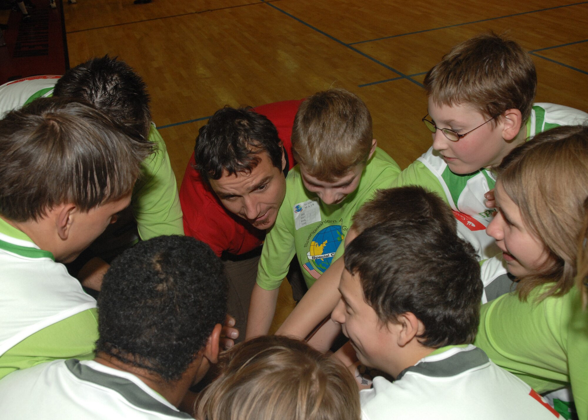 SPANGDAHLEM AIR BASE, Germany –- The children’s basketball team huddles up before their game against the Spangdahlem Air Base men’s team, as part of the St. Martin’s Children’s day, Oct. 30, 2008. The event included several individual games, cookout, basketball game, and awards ceremony. (U.S. Air Force photo by Airman Staci Miller)
