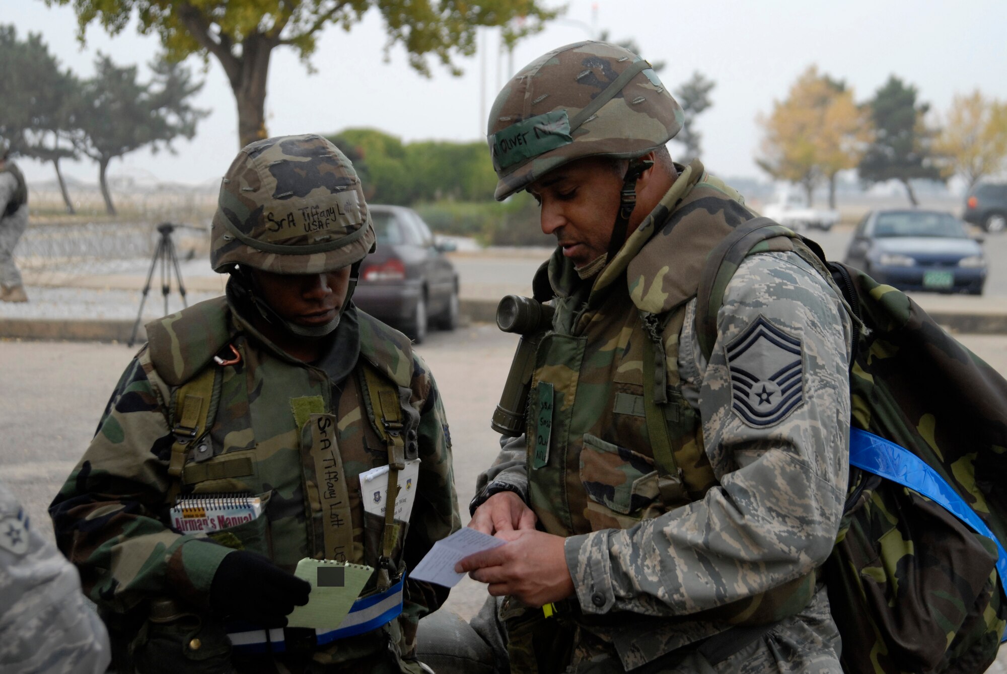 Senior Airman Tiffany Lott, a security forces augmentee from the 8th Operations Support Squadron, receives exercise related information from Senior Master Sgt. Oliver Niles, 8th Maintenance Operations Squadron, during the peninsula-wide exercise at Kunsan Air Base, Republic of Korea, Nov. 03, 2008. Kunsan is participating in the PENORE as a test of its wartime capabilities and response actions (U.S. Air Force Photo by SSgt Jason Colbert/RELEASED by SSgt Trevor Tiernan)