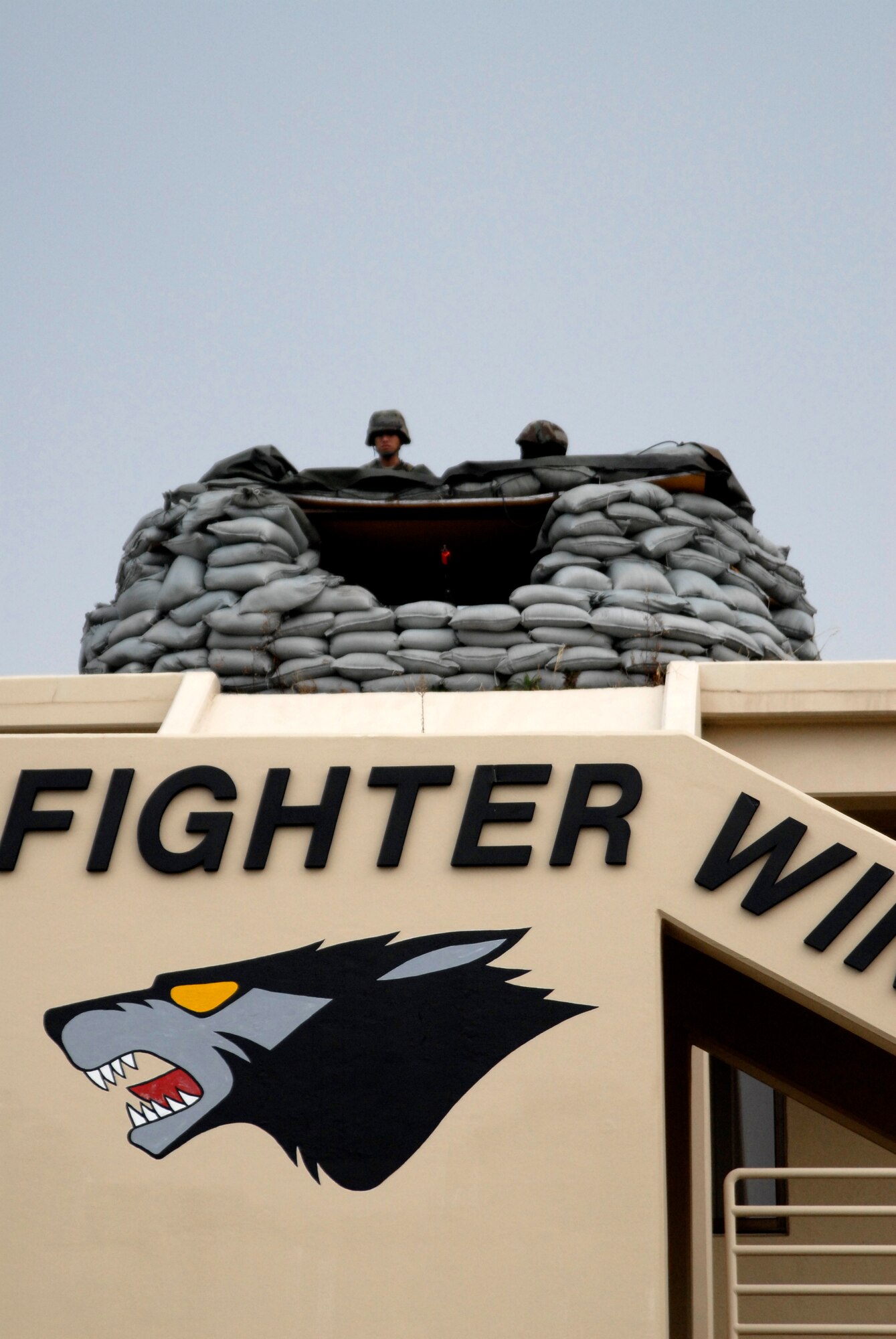 Airmen from the Wolf Pack scan for threats while manning a defensive fighting position in front of the 8th Fighter Wing headquarters building at Kunsan Air Base, Republic of Korea during the Peninsula-Wide Operational Readiness Exercise, Nov. 3, 2008. Kunsan is participating in the PENORE as a test of its wartime capabilities and response actions (U.S. Air Force Photo by SSgt Jason Colbert/Released
