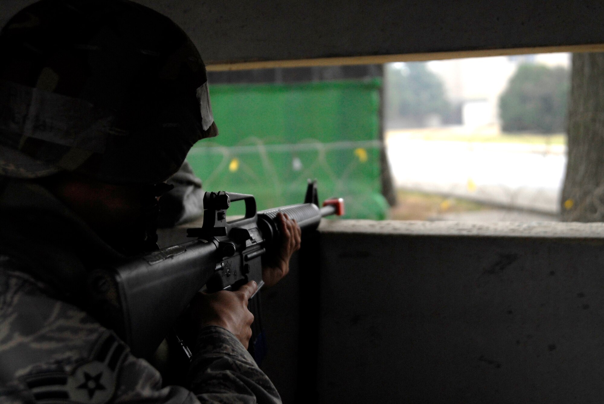 Airman 1st Class Andrew Villarreal, 8th Force Support Squadron, mans a defensive fighting position in front of the 8th Fighter Wing headquarters building at Kunsan Air Base, Republic of Korea during the Peninsula-Wide Operational Readiness Exercise, Nov. 3, 2008. Kunsan is participating in the PENORE as a test of its wartime capabilities and response actions (U.S. Air Force Photo by SSgt Jason Colbert/Released)