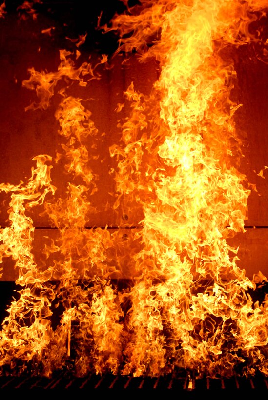 The fire inside the burn house grows in strength and begins to climb the walls during the training exercise, Oct. 29, 2008. During the excercise, soldier firefighters assigned 20th Engineer Brigade's 513th Fire Fighting Detachment will focus  suppressing a fire that has moved to the ceiling and is rapidly moving through the house.