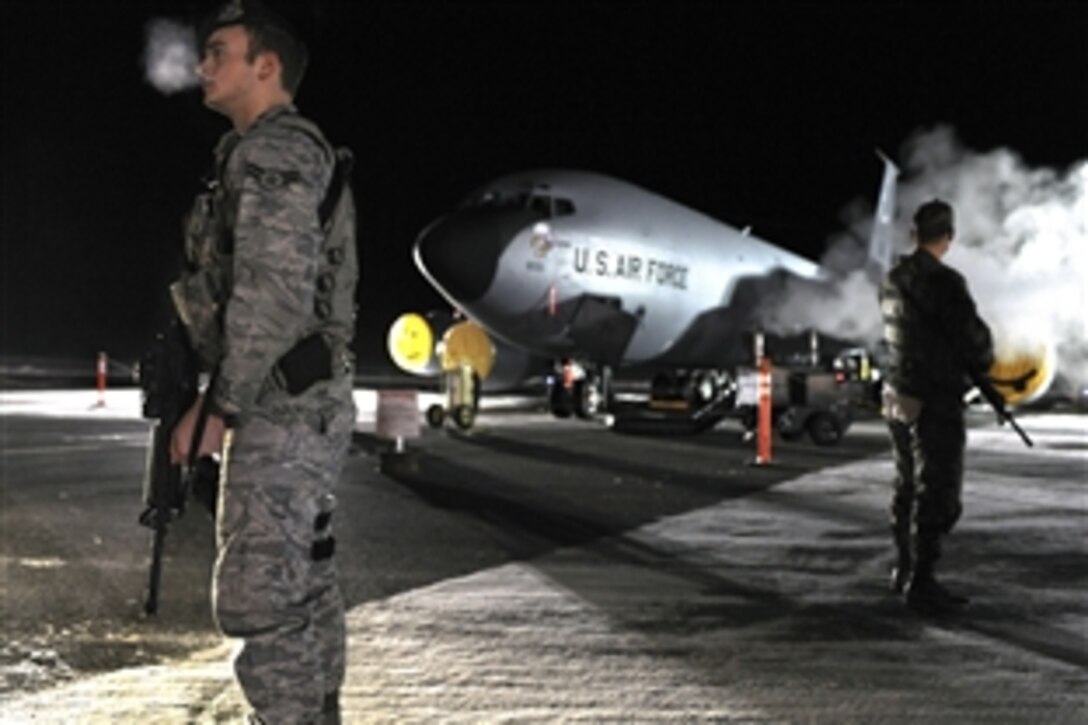 U.S. Air Force Airman 1st Class Tony Gross, left, and Airman 1st Class Laurence Tognetti, right, stand guard in front of a KC-135R Stratotanker during a readiness exercise on Eielson Air Force Base, Alaska, Nov. 1, 2008. Gross is assigned to the 354th Security Forces Squadron and Tognetti is assigned to the 354th Aircraft Maintenance Squadron. 