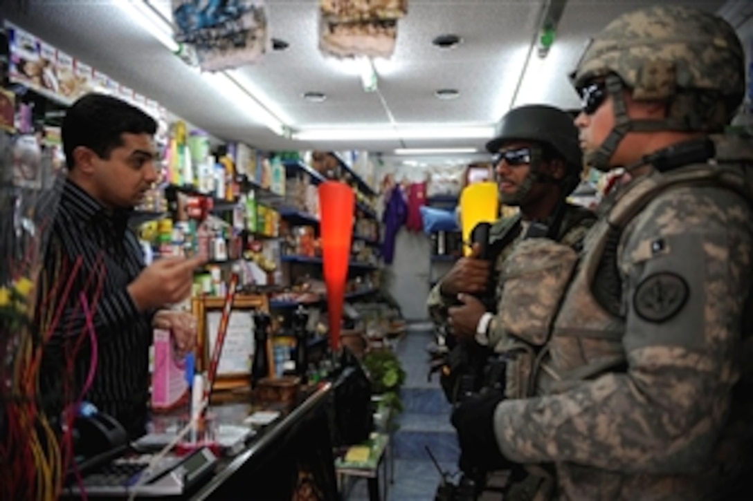 U.S. Army 1st Lt. John Nimmons and Iraqi army 2nd Lt. Ammar Hassin stop in a local store to meet with the owner during a joint operation patrol in Al Muhandiseen, Iraq, Oct. 30, 2008. Nimmons and fellow soldiers are assigned to the 3rd Armored Cavalry Regiment's 3rd Squadron.
