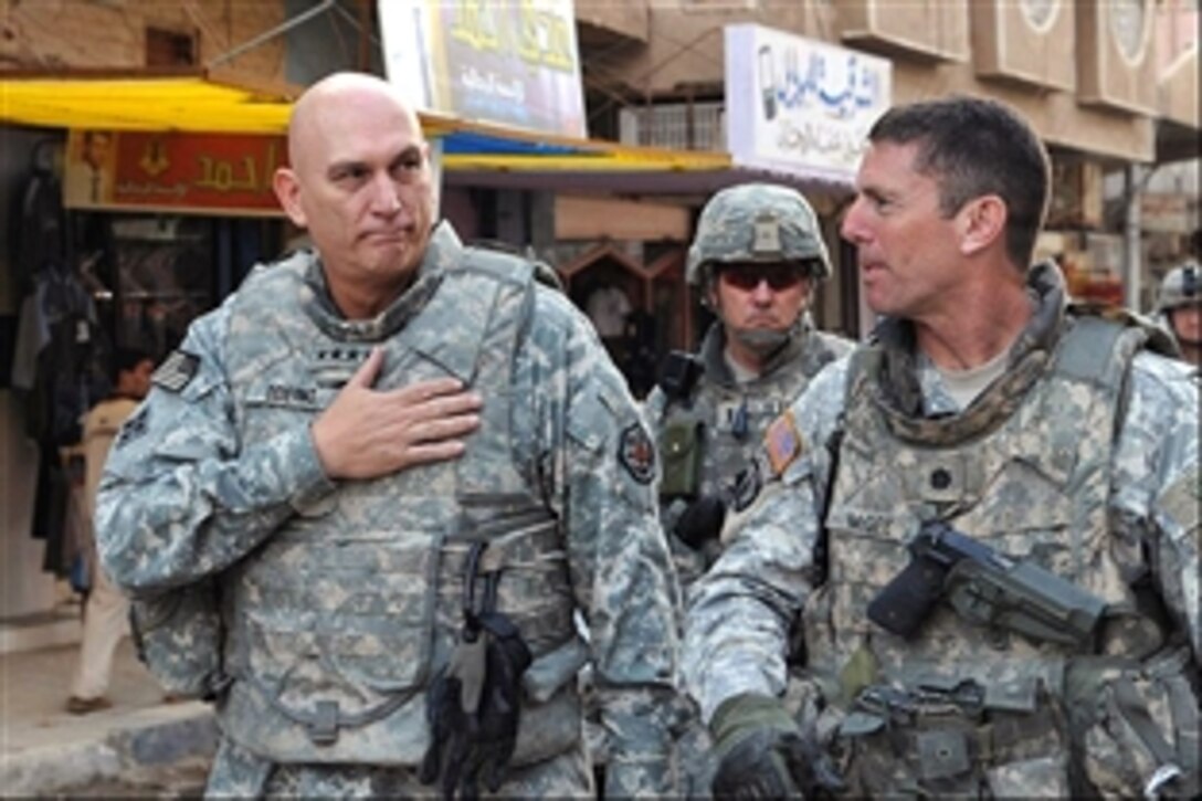 U.S. Army Gen. Ray Odierno, left, commanding general, Multinational Forces Iraq, and Lt. Col. Joseph McGee walk through the streets to visit local citizens in Samarra, Iraq, Oct. 29, 2008. McGee is the commander of the 101st Airborne Division's 2nd Battaltion, 327th Infantry Regiment.