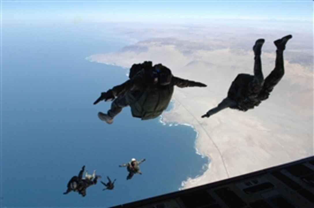A search and rescue team from the 48th Rescue Squadron out of Davis-Monthan Air Force Base, Ariz., jumps from the back of a C-17 Globemaster III aircraft alongside a Chilean airman over Iquique Air Base, Chile, in support of Operation Southern Partner on Oct. 30, 2008.  The operation is a two-week subject matter exchange emphasizing partnership, cooperation and sharing of information with partner nation air forces in Latin America.  The aircraft is assigned to the 535th Airlift Squadron out of Hickam Air Force Base, Hawaii.  