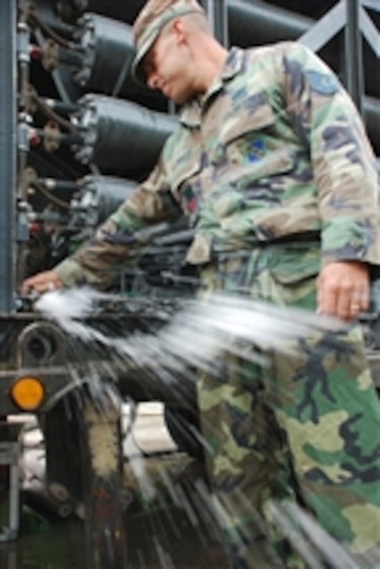 U.S. Air Force Tech. Sgt. Shane Bolles, from Joint Task Force - Bravo, works on a water filtration machine in Honduras on Oct. 29, 2008.  Service members from the task force are conducting a 10-day operation to filter well water in a community that lost access to potable water as a result of flooding.  