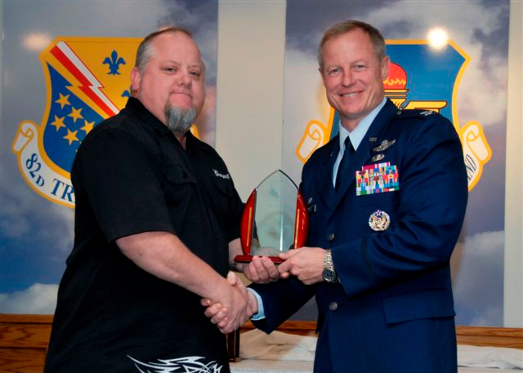 Col. David Petersen, 80th Flying Training Wing commander, presents Brian Seigars, 80th Operations Support Squadron, with the Category III Civilian of the Quarter award at the wing quarterly awards ceremony Oct. 21. (U.S. Air Force photo)