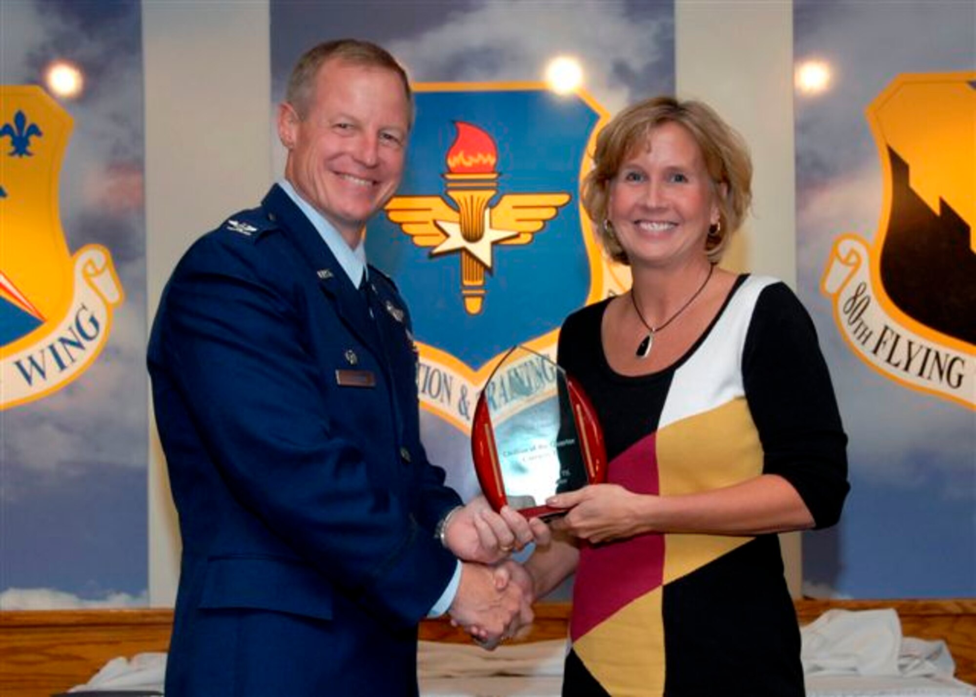 Col. David Petersen, 80th Flying Training Wing commander, presents Michele Houck, 80th FTW staff, with the Category II Civilian of the Quarter award at the wing quarterly awards ceremony Oct. 21. (U.S. Air Force photo)