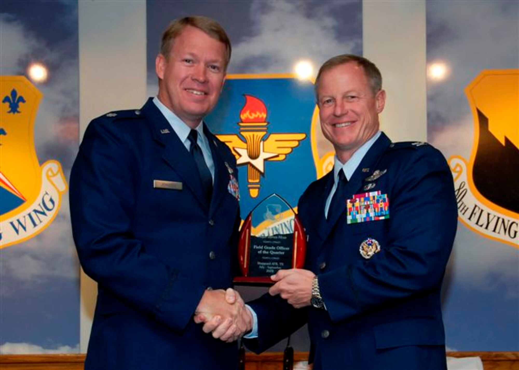 Col. David Petersen, 80th Flying Training Wing commander, presents Lt. Col. James Johnson, 80th FTW, with the Field Grade Officer of the Quarter award at the wing quarterly awards ceremony Oct. 21. (U.S. Air Force photo)