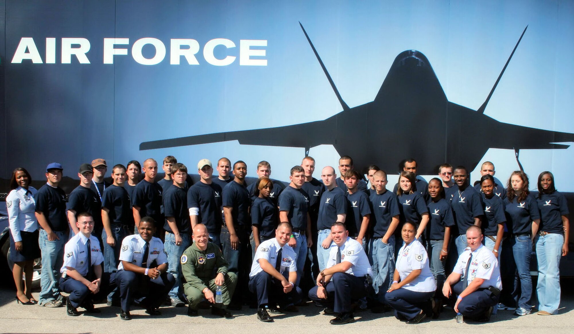 Members of the 331st Recruiting Squadron and the Delayed Entry Program pose in front of the Air Force's "Do Something Amazing Tour" following a swearing-in ceremony at the Sertoma Cajun Air Show Festival Nov. 1, in Lafayette, La. The tour is a mobile interactive display that allows visitors to get a close look at an F-16 Fighter jet and to learn more about Air Force capabilities and career opportunities. Recruiters from the 331RCS were on-hand at the air show to help answer questions and to induct 30 new recruits into the DEP. (U.S. Air Force photo)