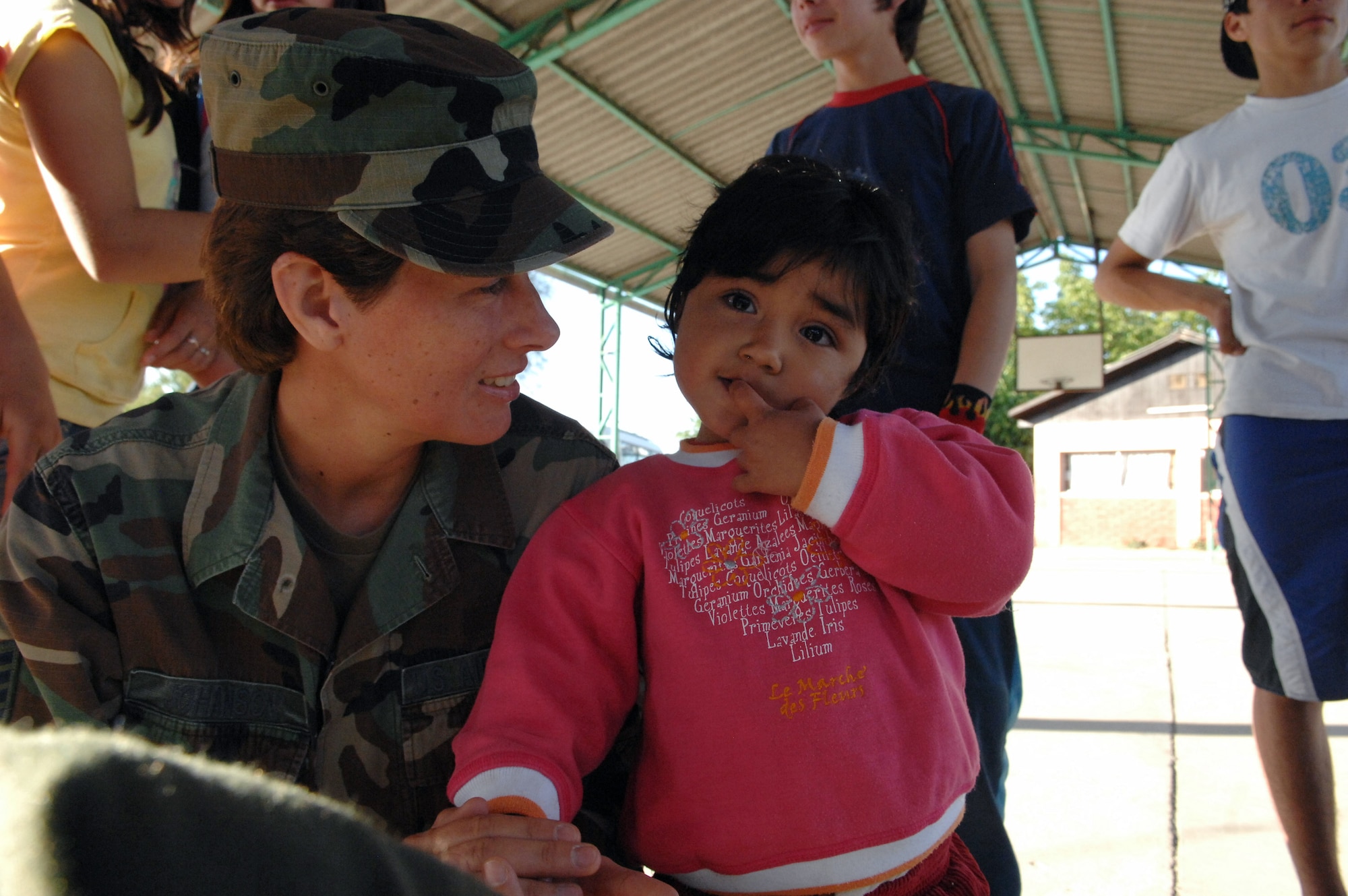 Staff Sgt. Mary Johanson holds a Chilean girl Oct. 30 at a home for abused or neglected children near Santiago, Chile. Sergeant Johanson is a 4th Combat Camera Squadron videographer from March Air Reserve Base, Calif. (U.S. Air Force photo/Tech. Sgt. Roy Santana)