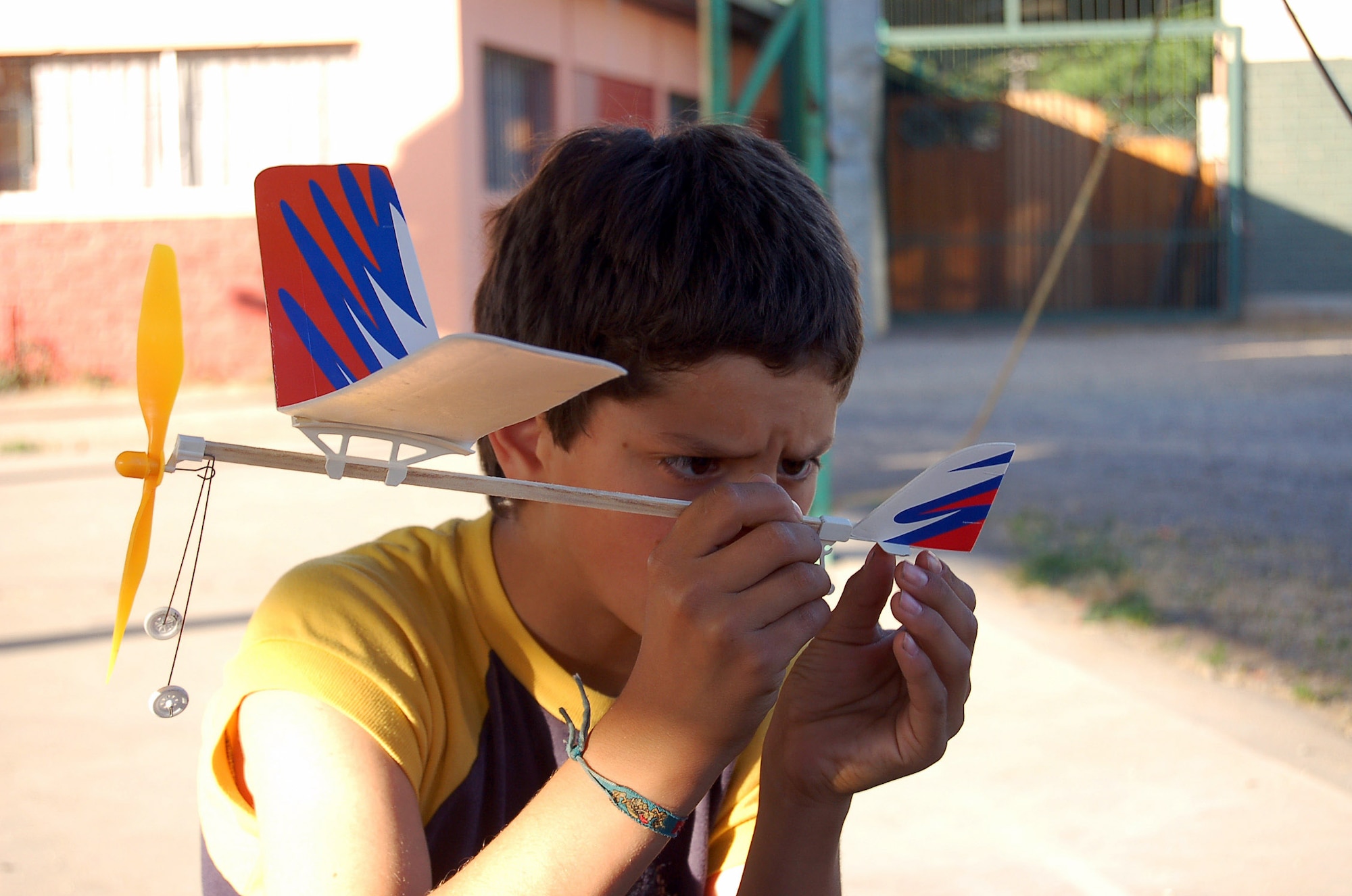 A Chilean boy inspects a model airplane he constructed Oct. 30 at a home for abused or neglected children near Santiago, Chile. Airmen visited the home while they are providing intensive, periodic subject-matter exchanges in the U.S. Southern Command area of focus. Besides helping construct the model airplanes, the Airmen held a cooking exchange where the children were treated with baked treats of carrot and red Velvet cakes. (U.S. Air Force photo/Master Sgt. Eric M. Grill)
