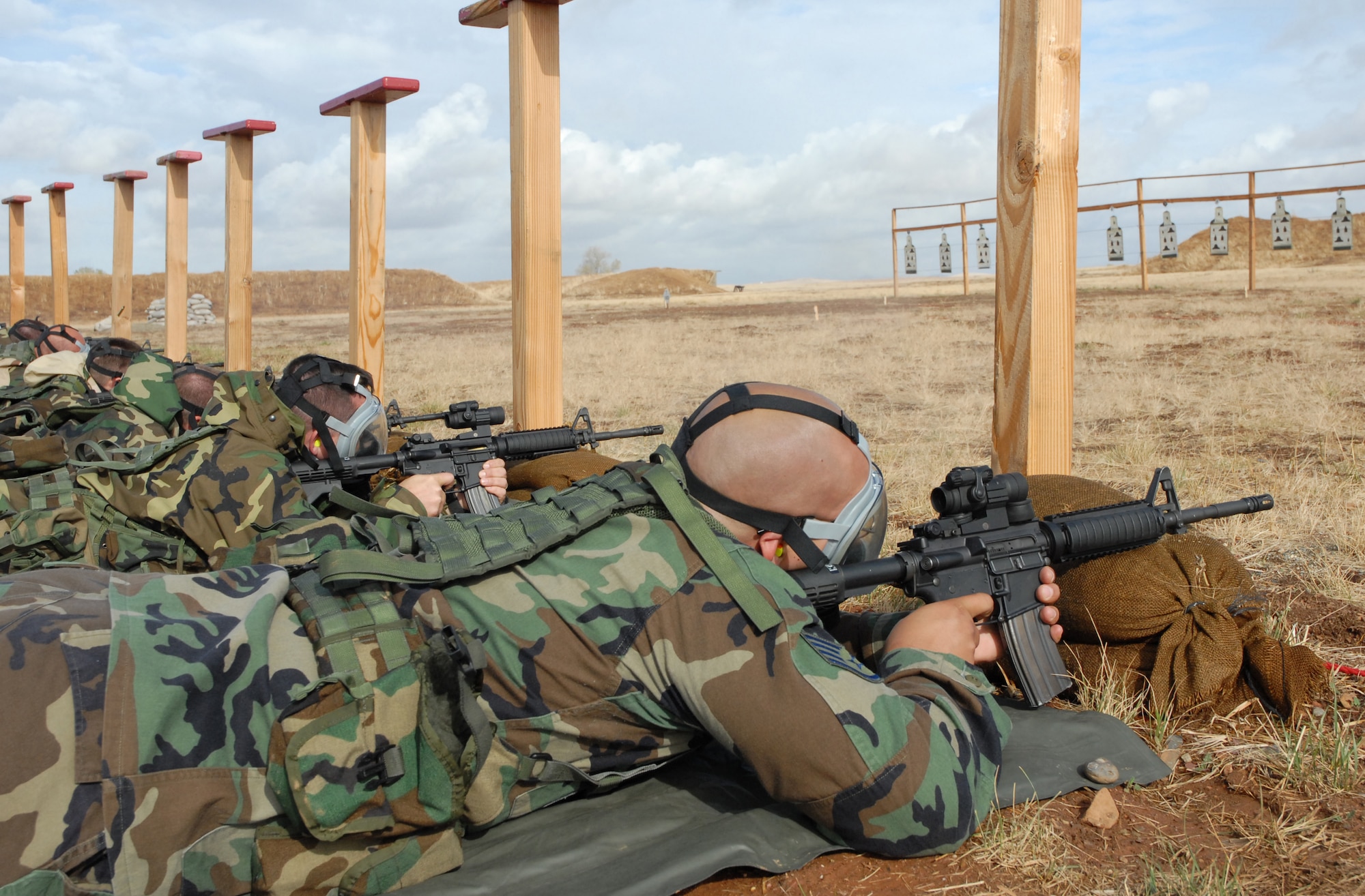 BEALE AIR FORCE BASE, Calif. -- Citizen Warriors from the 940th Air Refueling Wing's Security Forces Squadron sight M-4 rifles down range while wearing MCU-2 protective gas masks during a qualification rifle shoot on the November unit training assembly weekend here. 940th SFS Airmen are required to maintain the same level of combat readiness as their active duty counterparts.  
(U.S. Force Photo/ Tech. Sgt. Luke Johnson) 