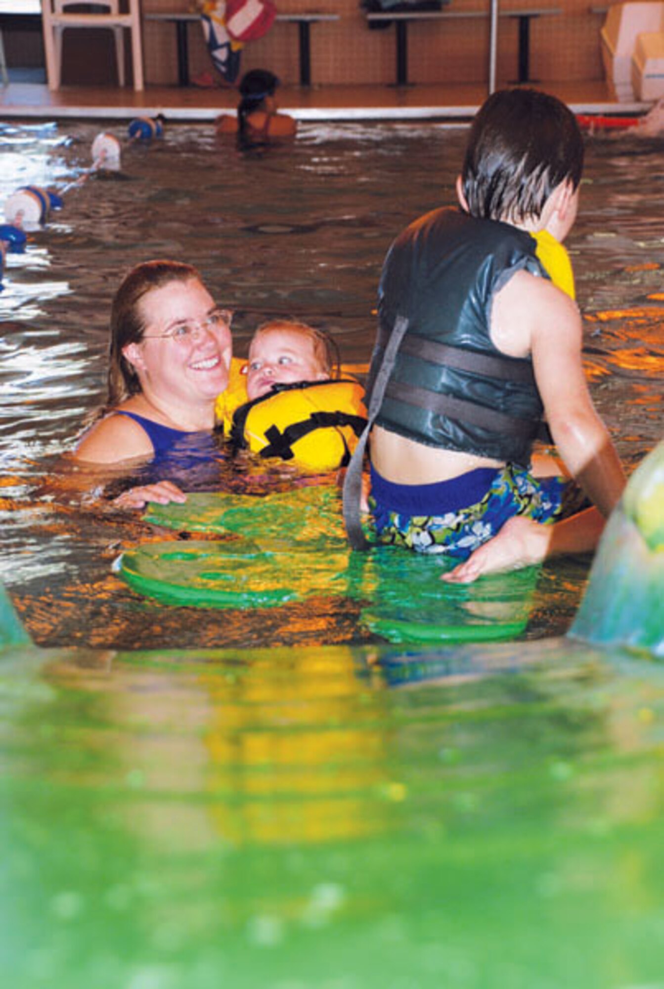 Kate Fogg, wife of Tech. Sgt. Chad Fogg, and children Ellen and Ryan, play during the Spooky Swim at the Warren Aquatic Center Saturday from 1 to 4 p.m. The Spooky Swim party offered participants activities like coloring contests and games.